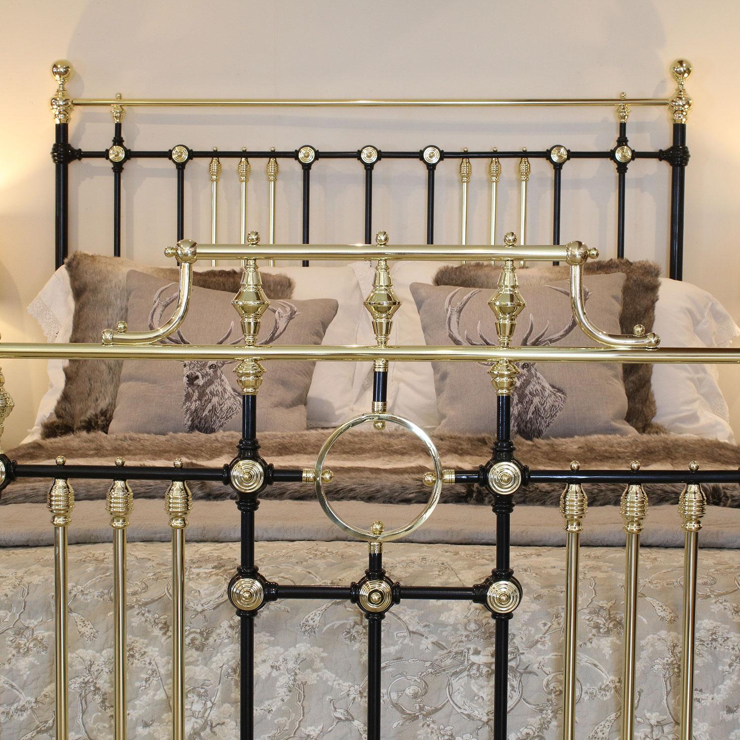 A superb brass and iron bedstead adapted from an original Victorian frame, finished in black with decorative brass rosettes, brass ring and raised gallery.

This bed accepts a British king-size or US queen-size (measure: 5ft, 60 in or 150cm wide)