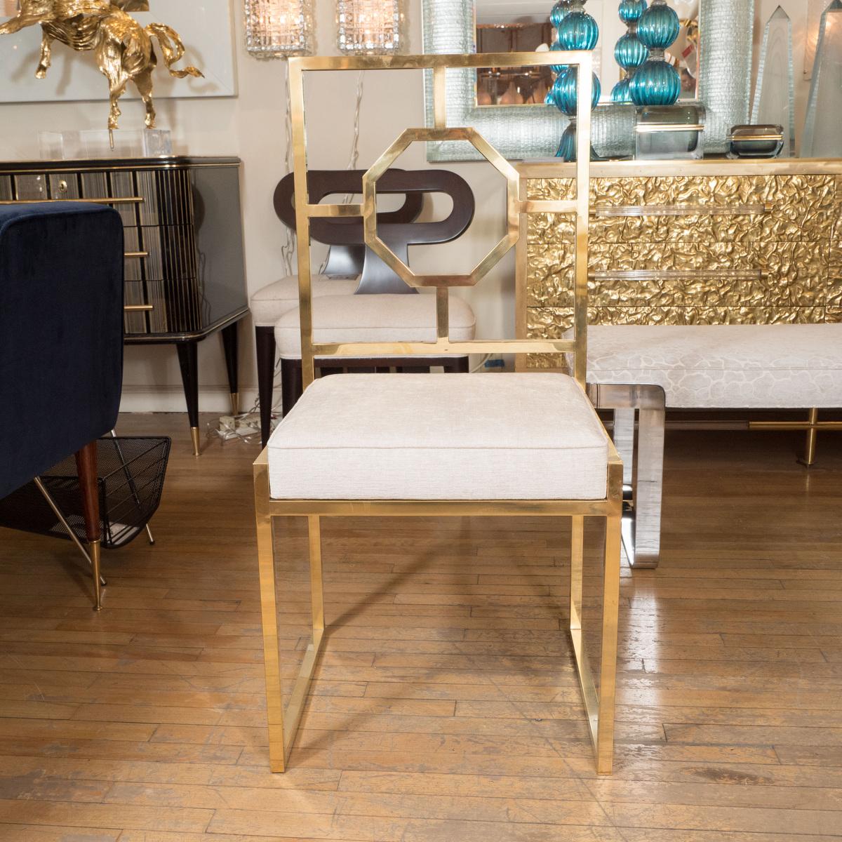 Decorative brass chair with upholstered seat.