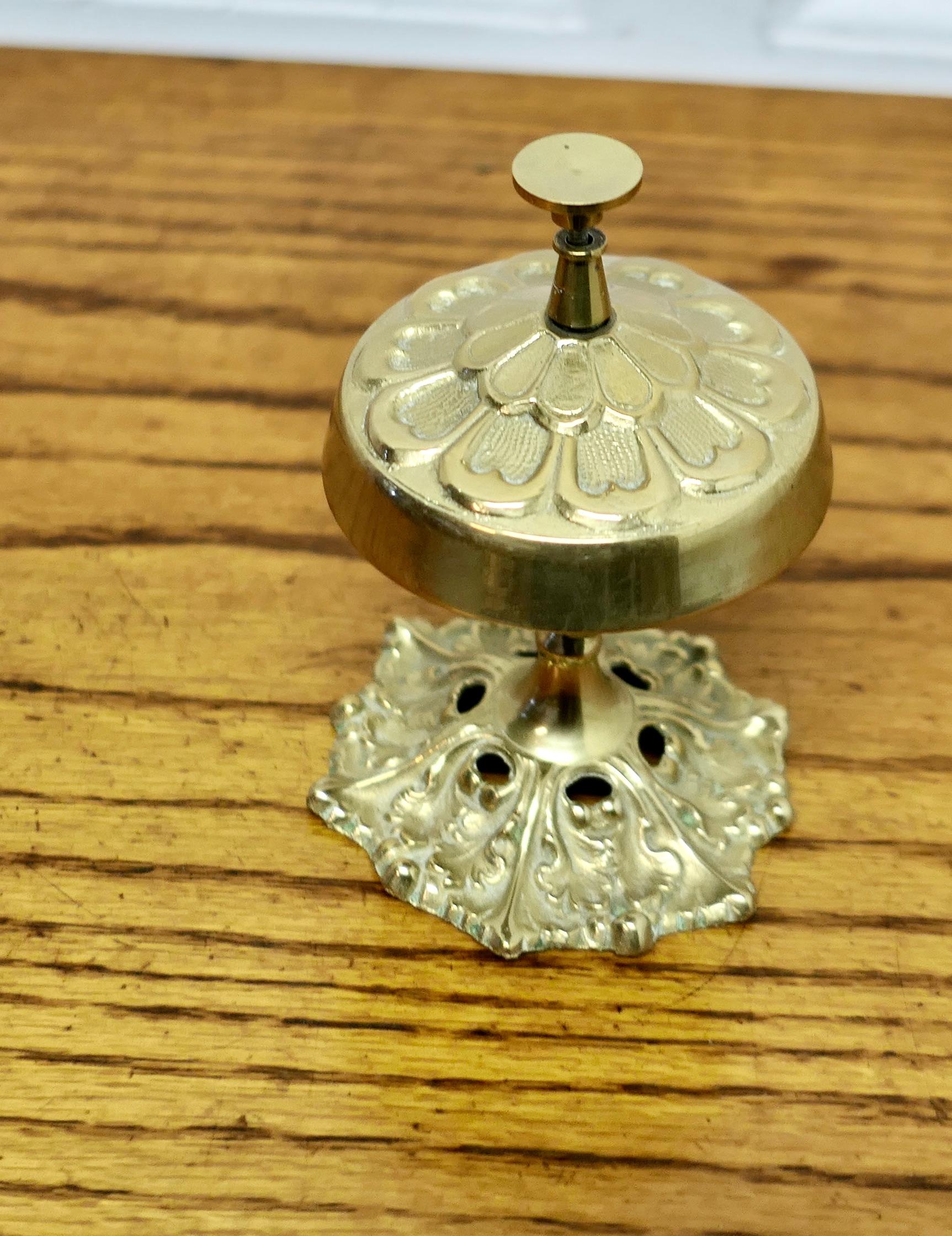 Decorative Brass Courtesy Counter Top Bell

Made in a floral style in solid brass, good and ready to use with a high pitched ding, the bell is 3” in diameter and 5” high 
TVY146