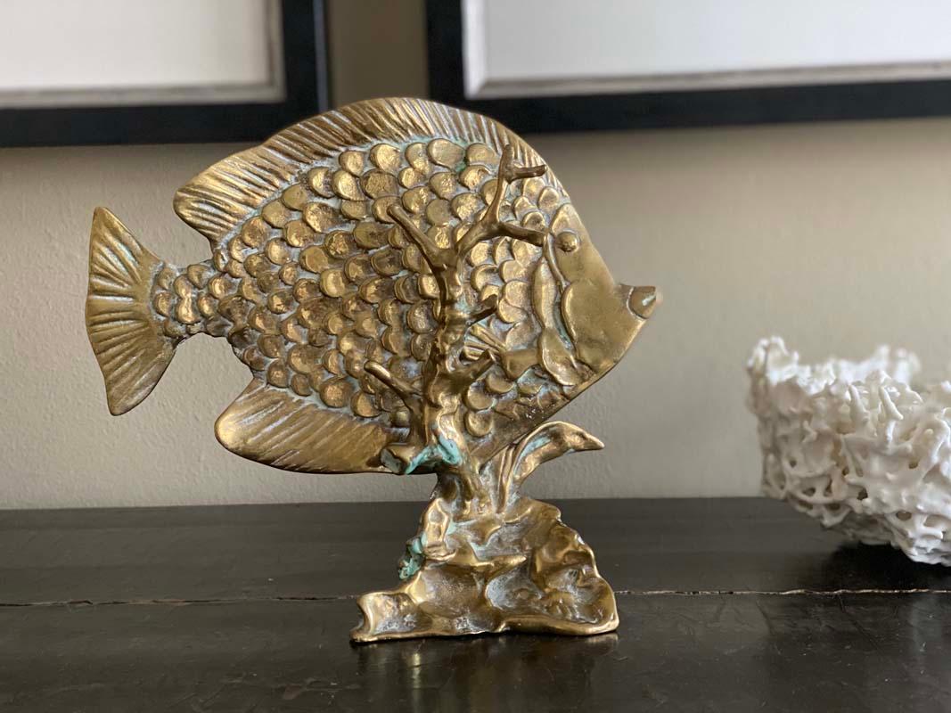 Rare brass fish sculpture from the 20th century. The special thing about the sculpture, it consists of two parts. The fish is put into the coral. A beautiful maritime decoration, which can actually be combined well with everything and by its small