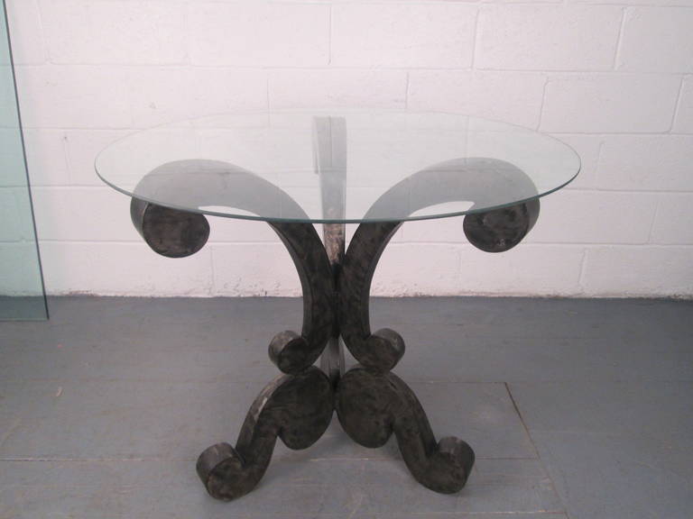 Decorative brushed steel center table with round glass top.