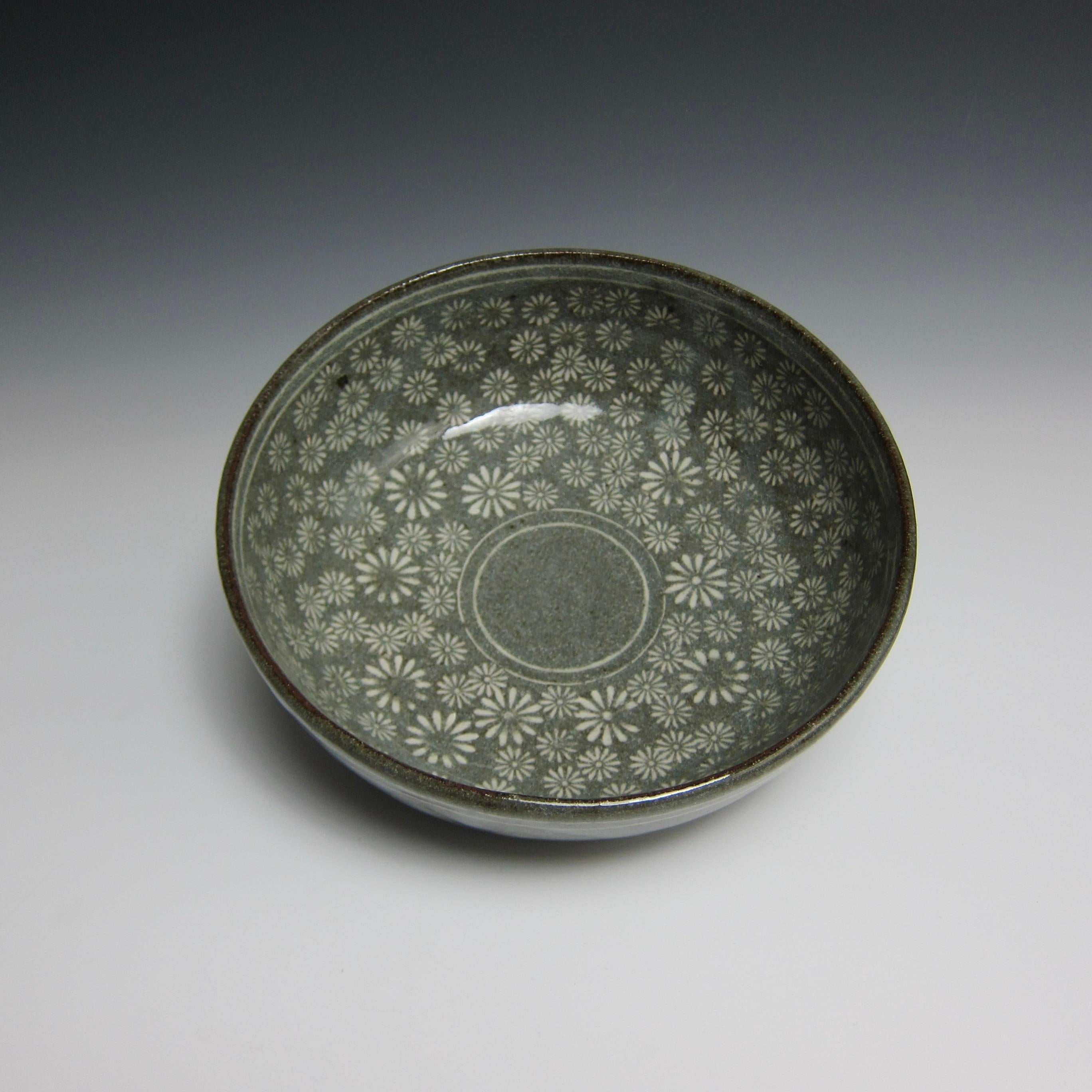 Wheel thrown flower stamped buncheong bowl by Jason Fox

2 3/4