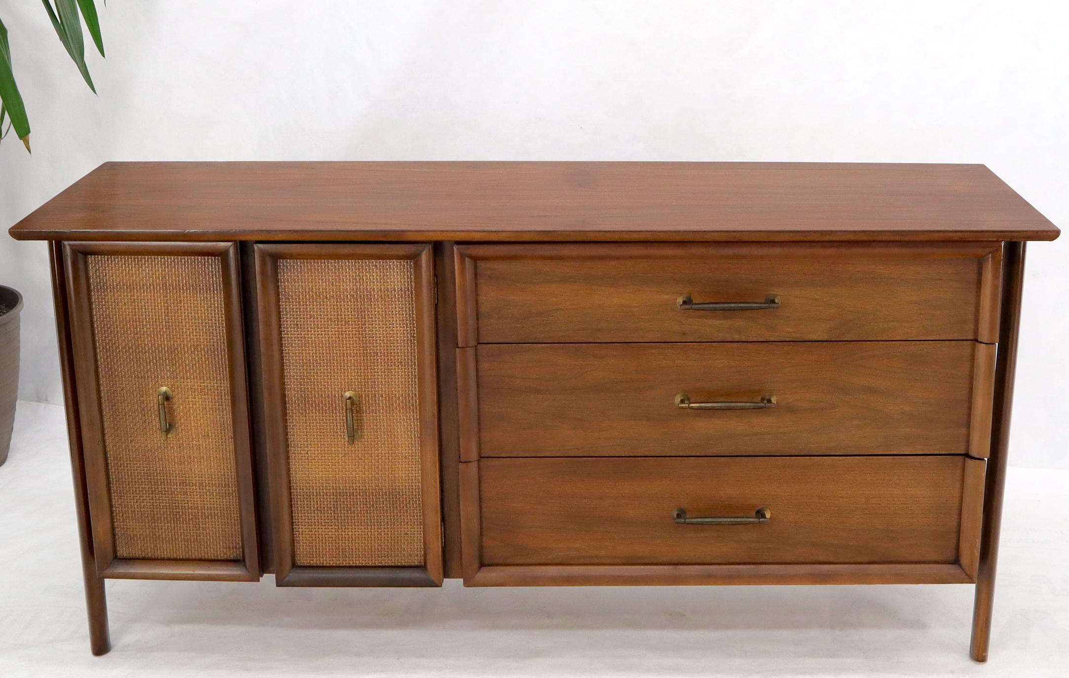 Mid-Century Modern walnut threee drawers credenza with double doors cane front compartment.