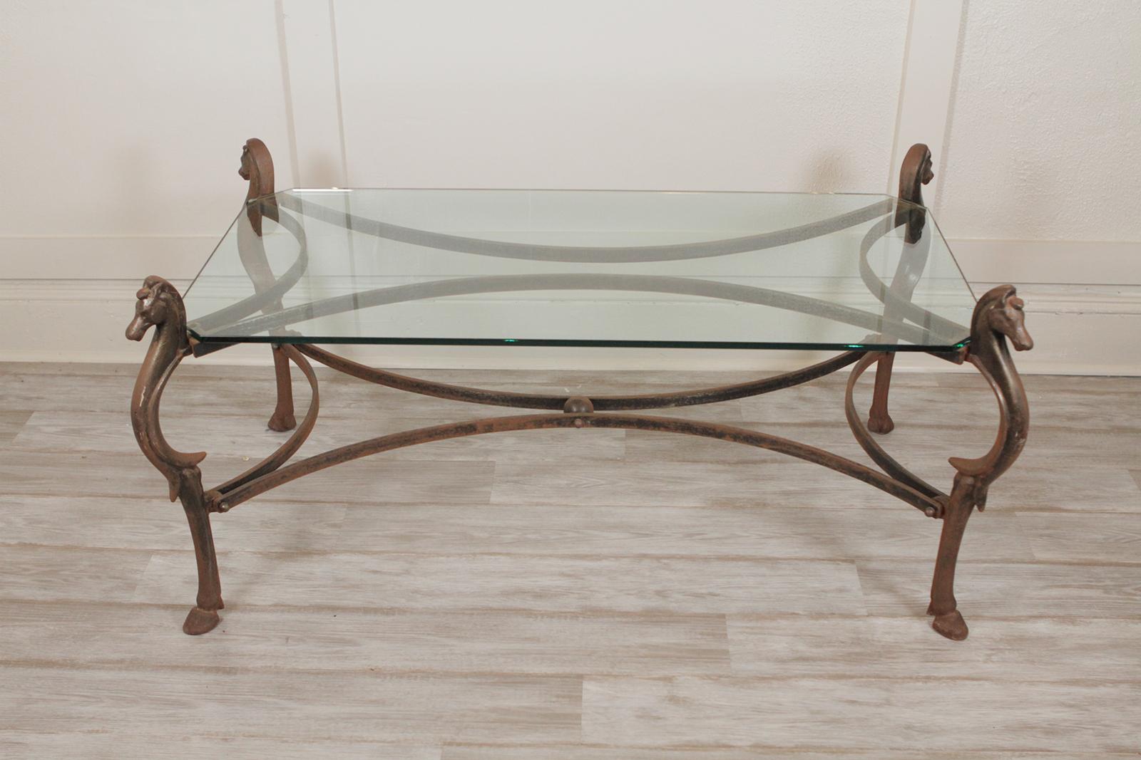 Decorative cast iron and glass top cocktail or coffee table with horse head legs
Dimensions: 48” L X 24” W X 12” H.
