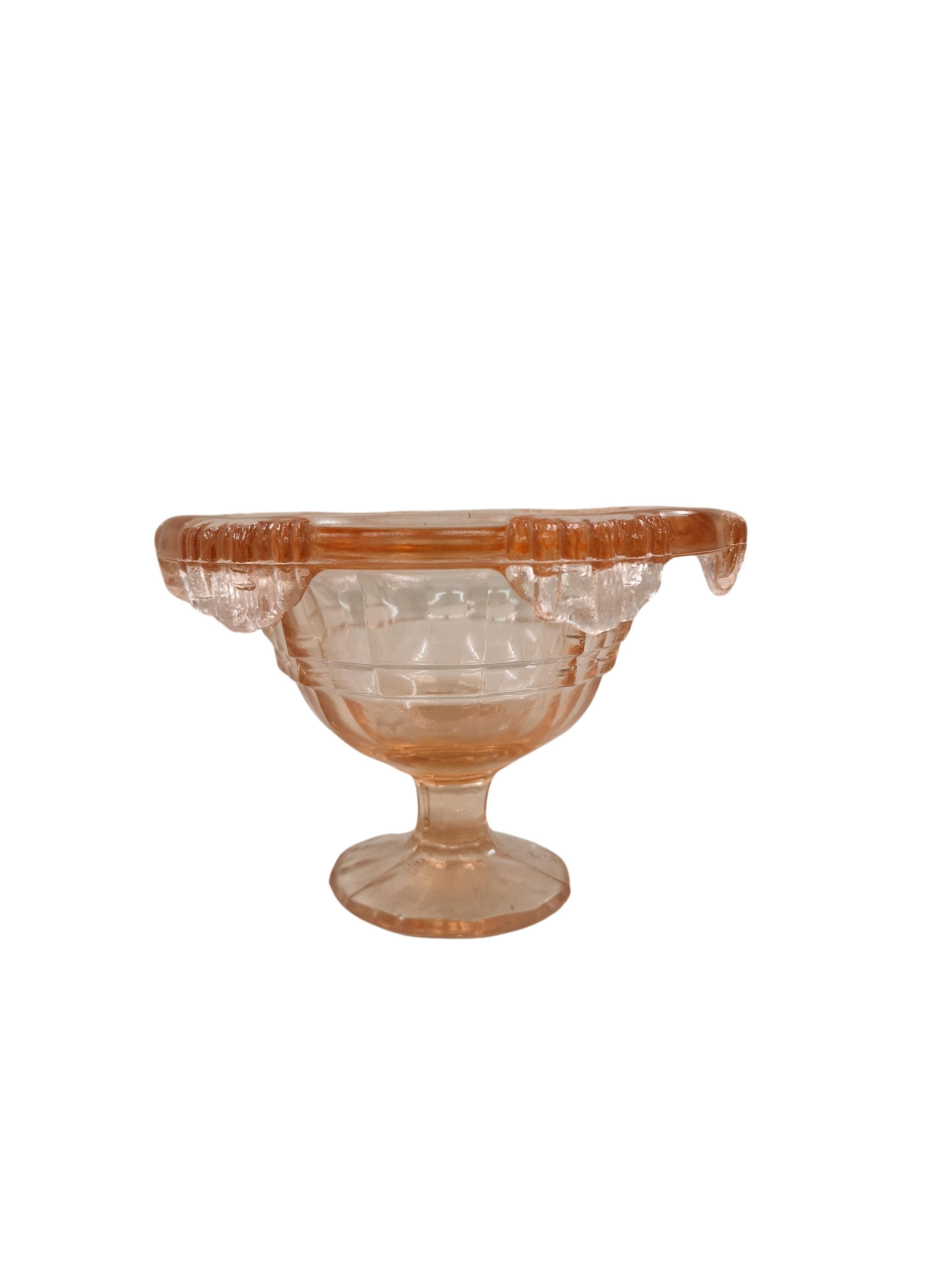 Wonderful centerpiece out of pink glass in elaborate design, an original of the Art Deco period, made in the 1930s in Italy. 

The object is of a special design. The base is round and stepped. The body opens upwards to reveal a round bowl. There are