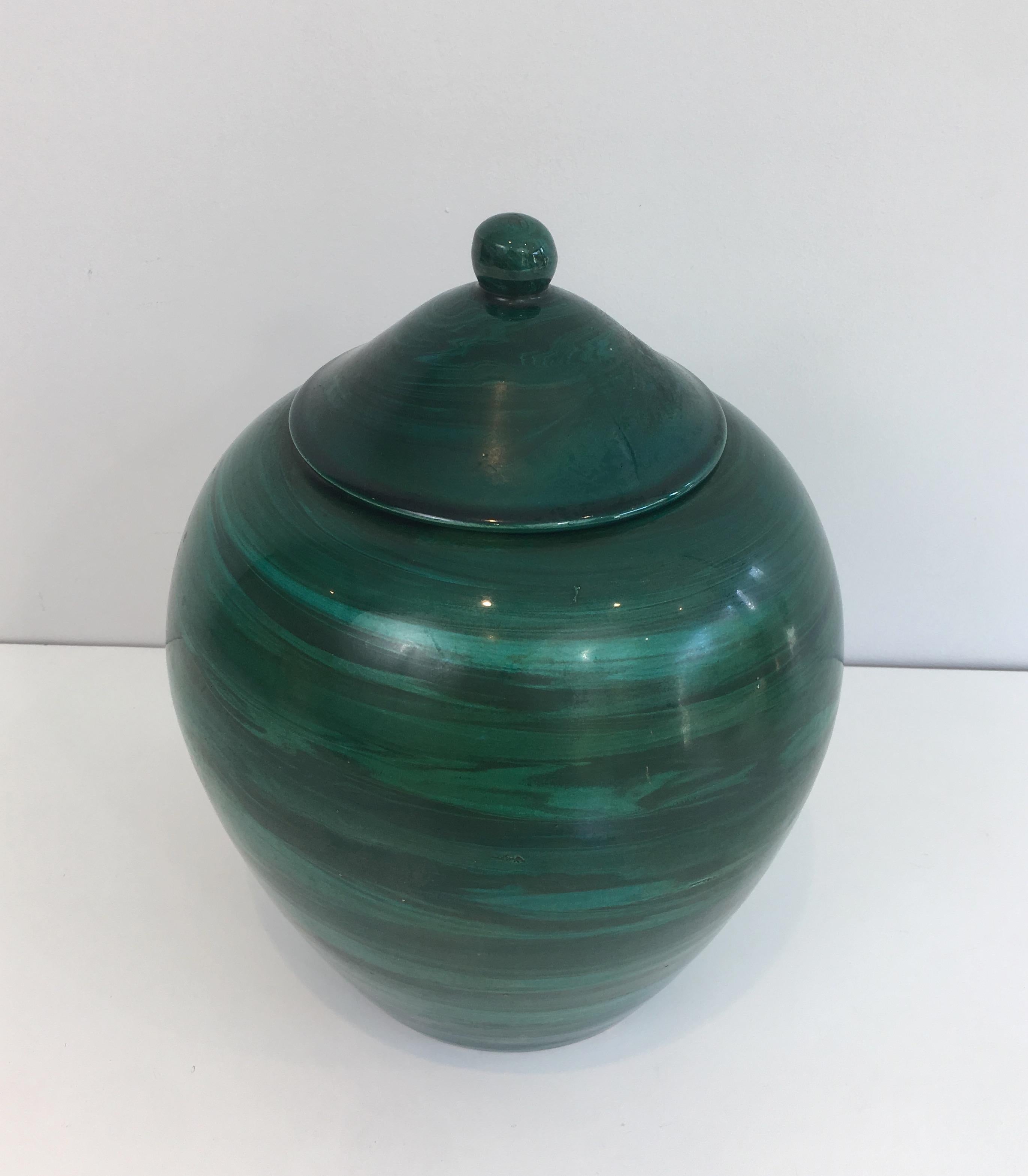 This decorative covered pot is made of ceramic in the green nuances. This is a French work, circa 1950.