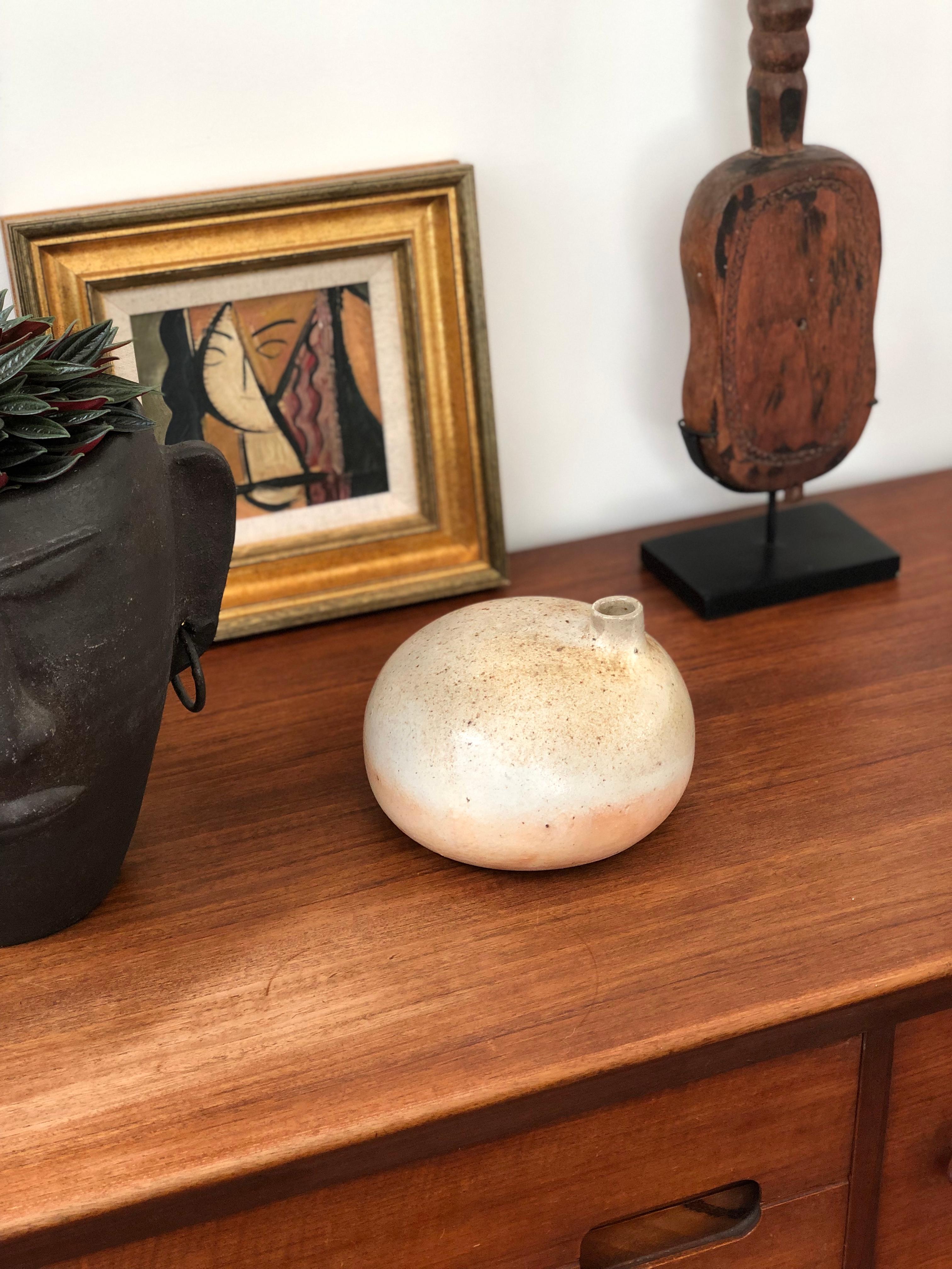 Decorative ceramic vase by Michel Lodereau, circa 1970s. The artist's trademark style is the creation of elegant pieces in sandstone with smooth glaze and subtle colouring. This piece has sensuous curves with a simple spout reminding one of a bird
