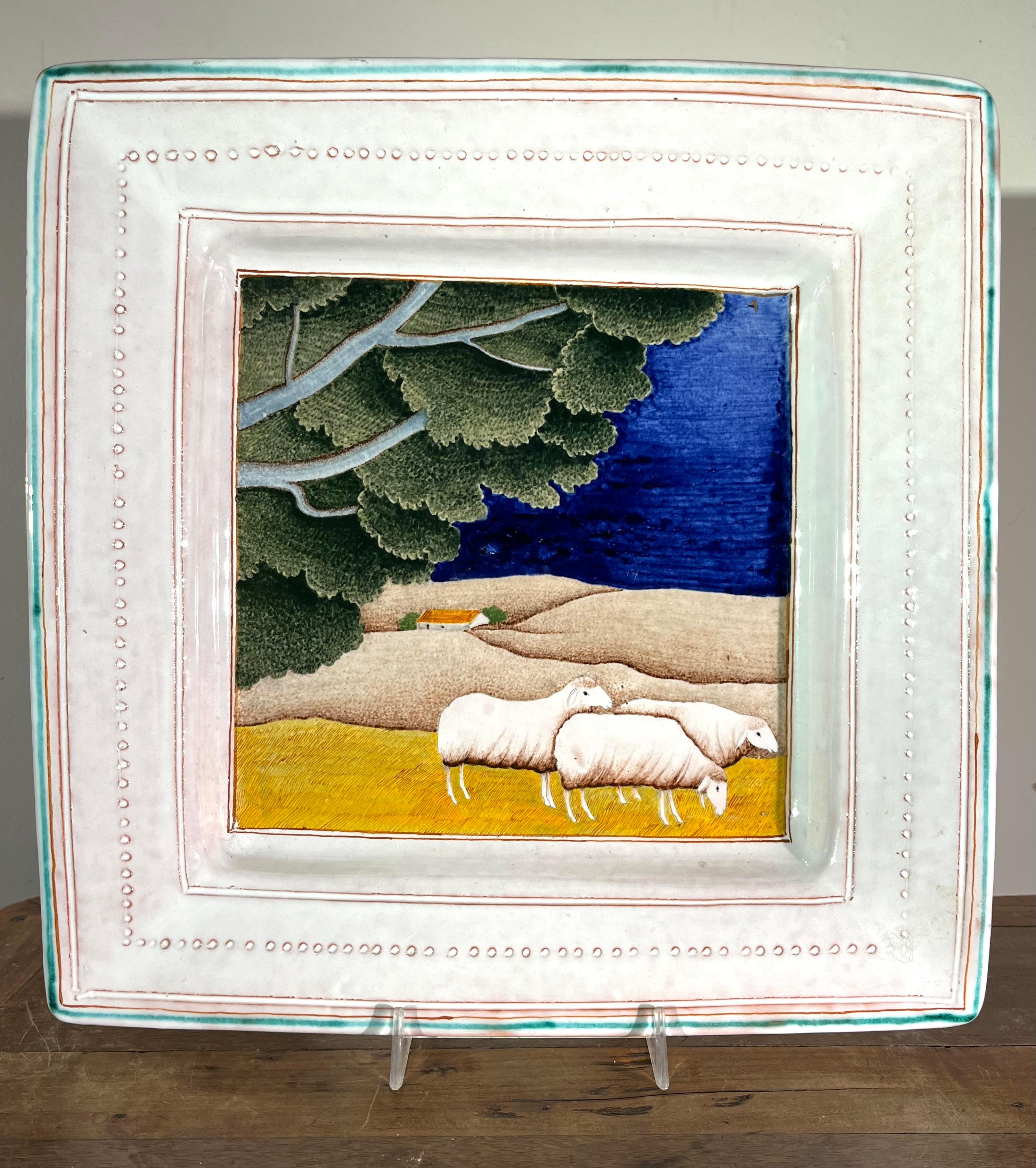 A charming decorated charger in hand-painted faience, by Claude (1927-2008) and Slavik (1920-2005) Palley. The Palleys created their pieces in Ivy-Sur-Seine France and were exclusively represented by Pierre Deux through the 70’s and 80’s. This