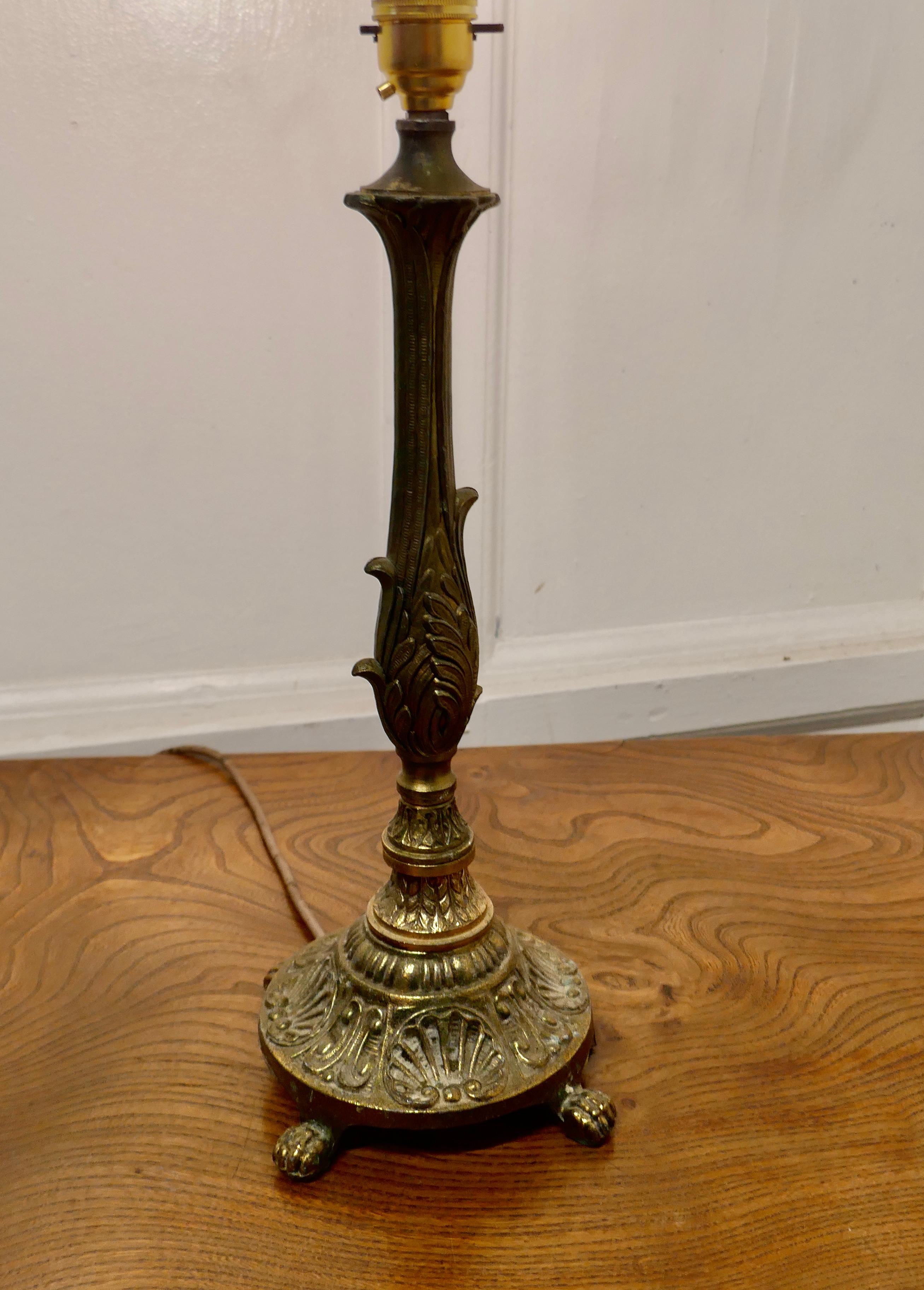 Decorative chased brass table lamp

This is good heavy brass piece, the lamp has a decorative central column set on a round base with with clawfeet 
This is an attractive piece with a good patina.
The lamp is 17” tall (to the bayonet) and stands