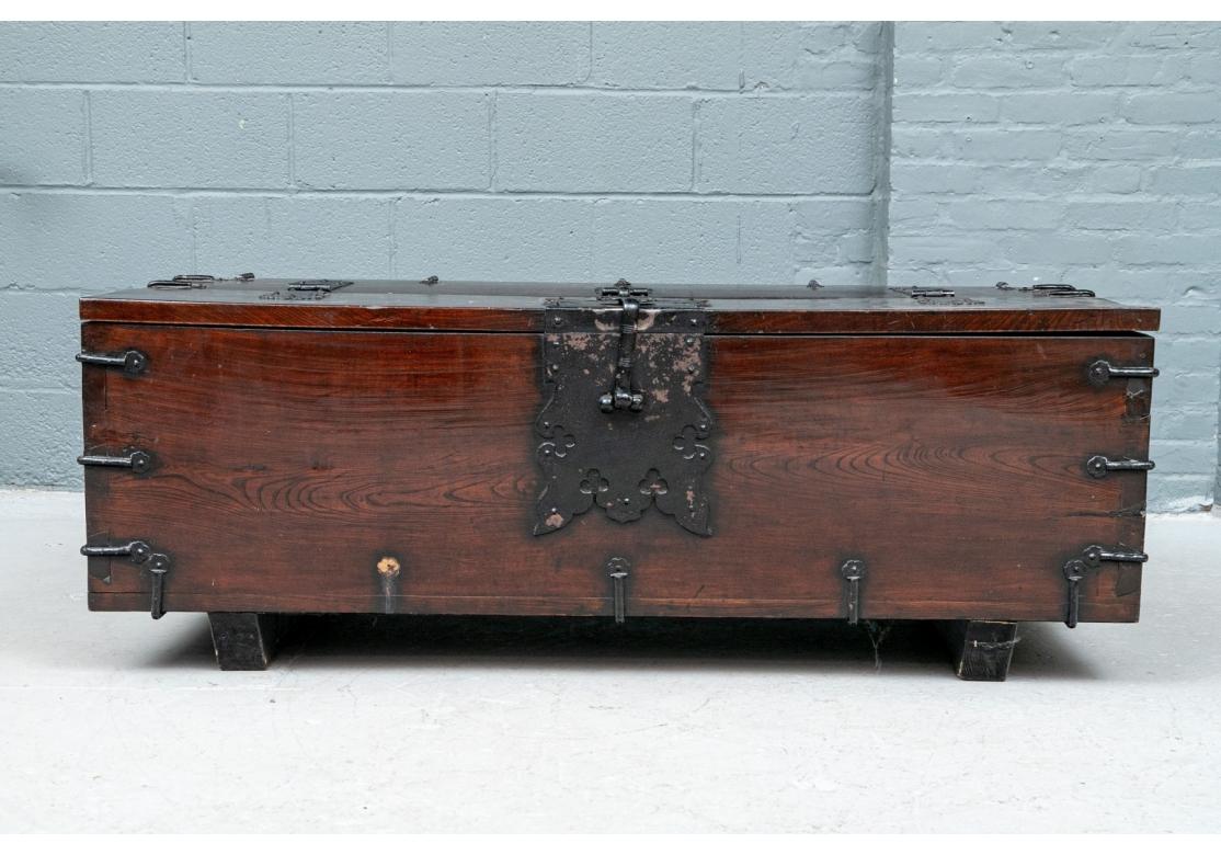 Heavy wooden storage chest with chunky and prominent iron hardware. The chest opens from the front top with heavy 1