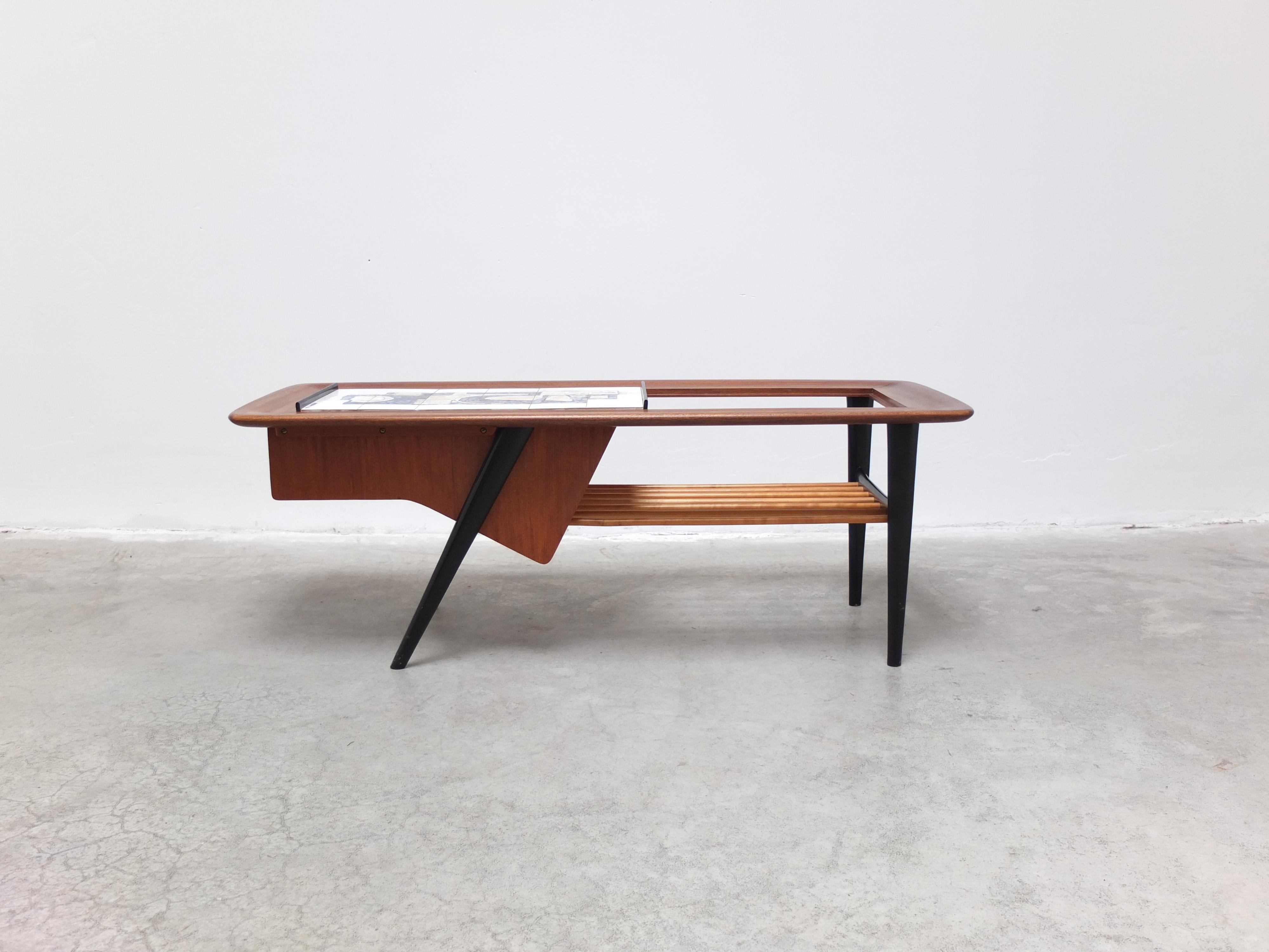 Beautiful coffee table designed by Alfred Hendrickx for Belform around 1957. A very decorative piece thanks to elegant asymmetric frame and the abstract artwork by Willy Meysmans on the ceramic tile which also slides open to reveal a bar area. A