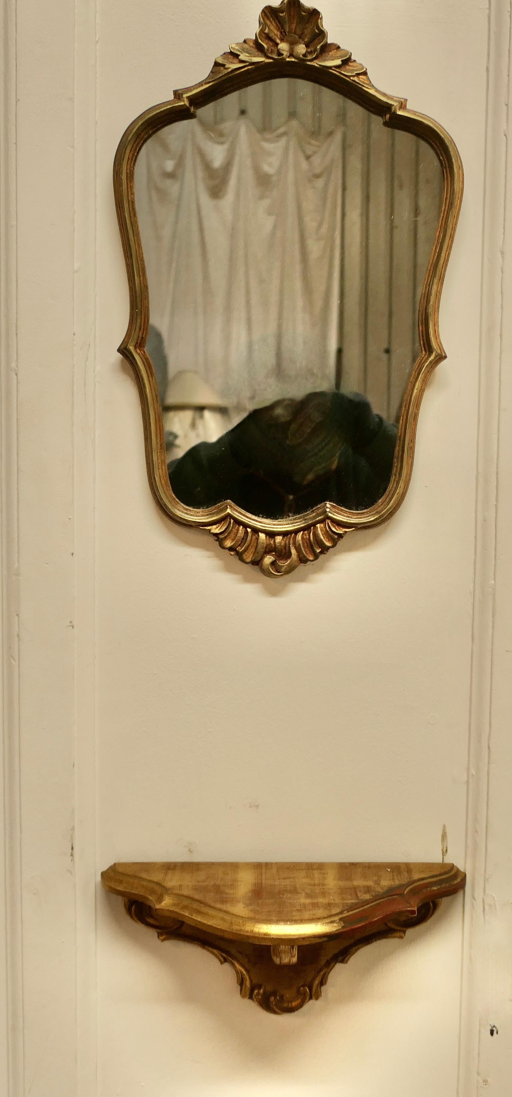 Decorative Console Mirror with Shelf Under

This is an attractive dainty piece the mirror has a shell decoration above and below, and it can be set any height over the matching shelf

A really attractive pair in good attractive condition  

The