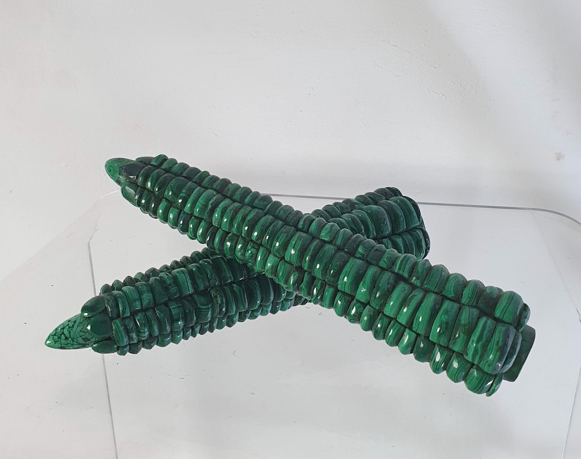 A pair of handmade corn on the cob in malachite intended for decoration.