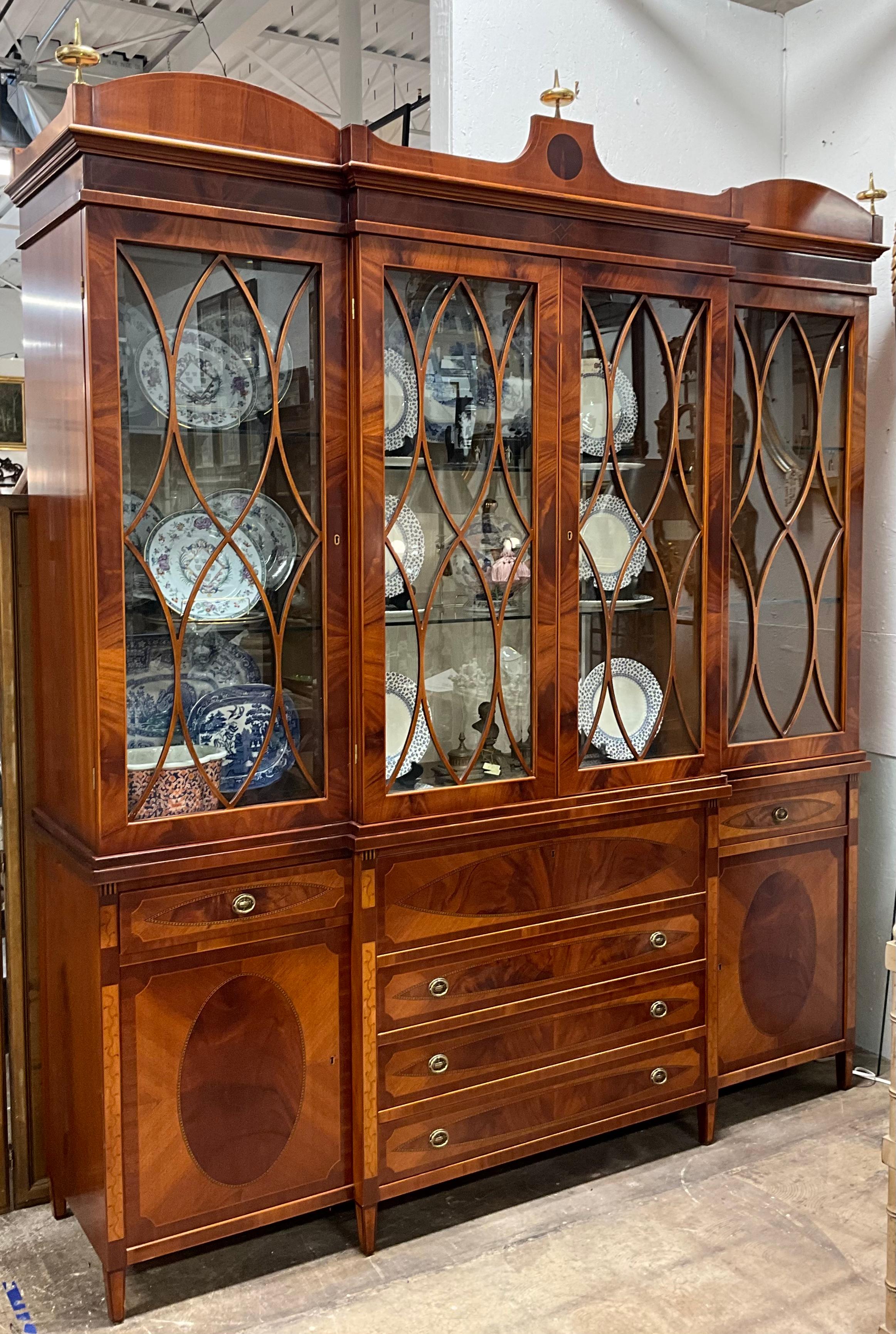 This is a fabulous cabinet! It is an Italian cabinet by Decorative Crafts. It is a combination of satinwood, mahogany, and cherry woods. The top portion is lined with an embossed ivory damask and is electrified with glass shelves. The piece has