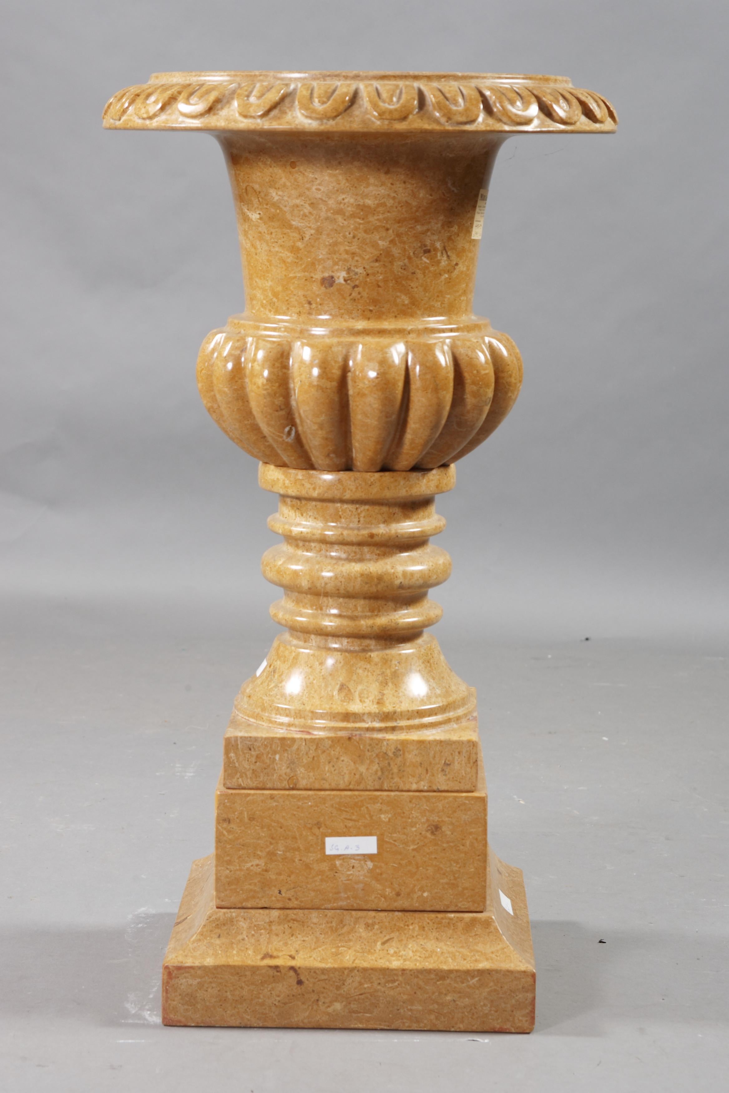 Decorative marble cratervase in the style of classicism natural marble in golden yellow. Quadrilateral going into curly shaft. Ovoider body slightly conically rising neck and wide, arched and decorated edge. The entire crater vase is handmade.