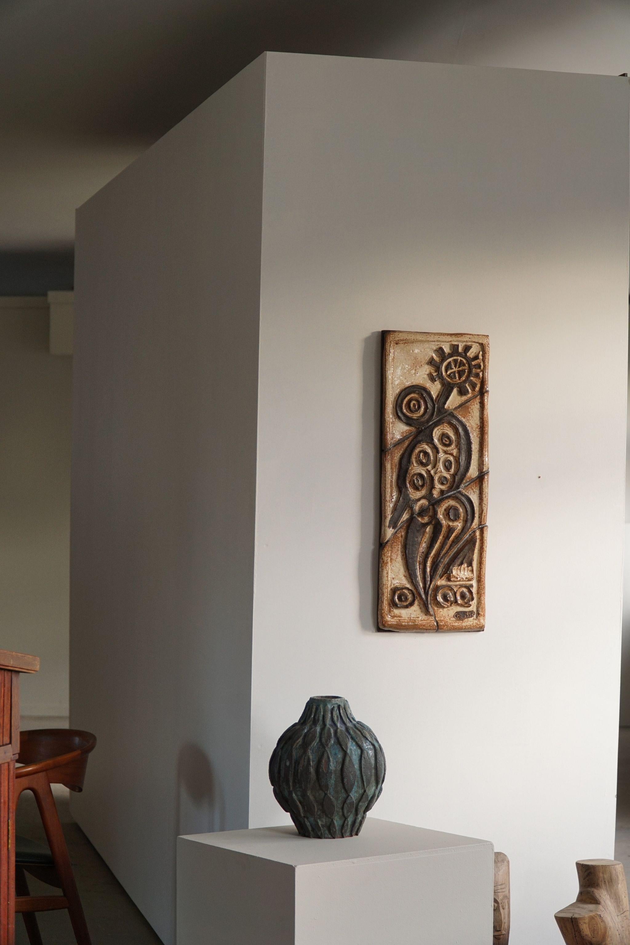 A fine unique sculptural stoneware wall unit in various brown and beige colors, mounted on a wooden plate. Signed CF 1970.

Nice texture and dimensions in this vintage piece. This brutalist object fits in many interior styles. Modern interior, Art