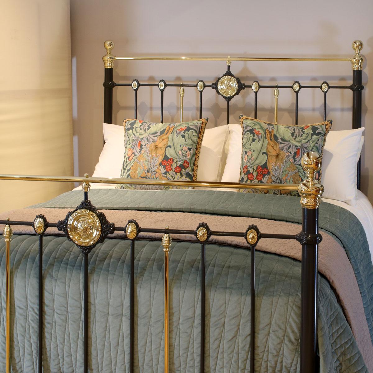 Antique bed in dark grey with brass top rail, decorative castings and double ended brass rosettes.

This bed accepts a UK King size or US Queen size (5ft, 60in or 150cm wide) base and mattress set.

The price includes a standard firm bed base to