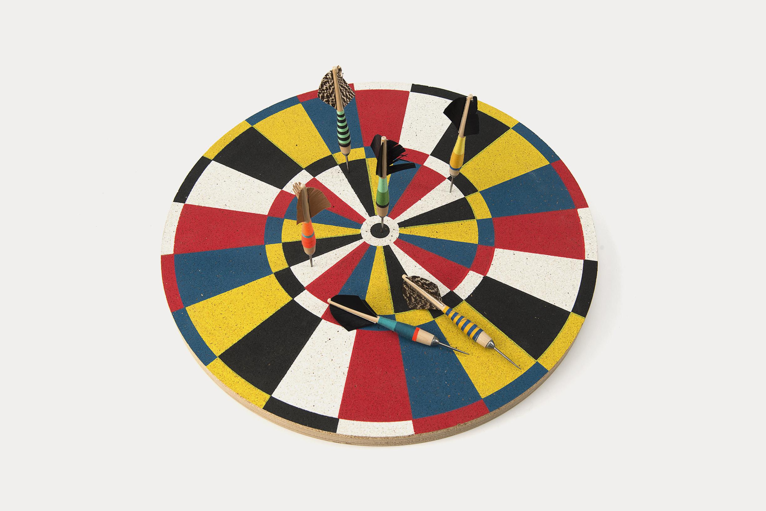 Five-color silk-screened cork with a key hole on the back for easy hanging. Makes a wonderful wall accessory.

The dartboard may have its origins in the cross-section of a tree - as the wood dried, cracks would develop, creating 