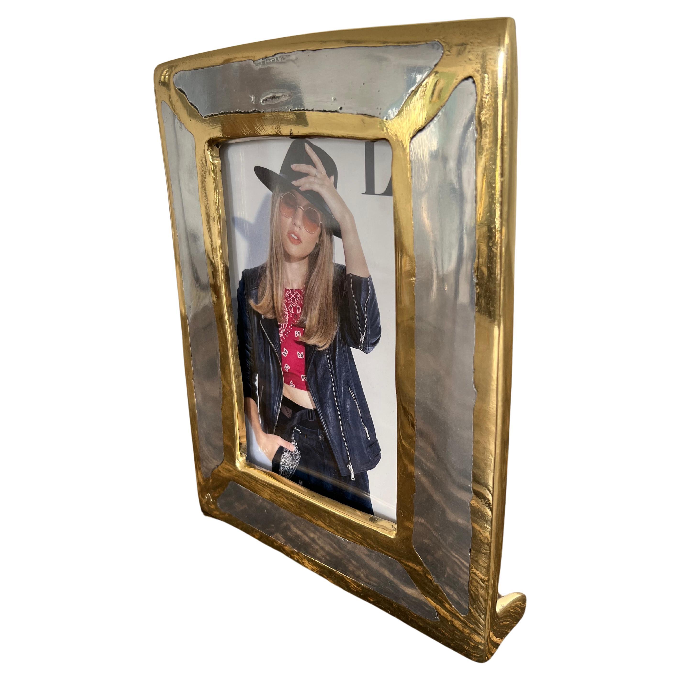 The decorative diagonal picture frame was created by David Marshall, it is made of sand cast aluminum and sand cast brass.
Handmade, mounted and finished in our foundry and workshop in Spain from recycled materials.
Certified authentic by the