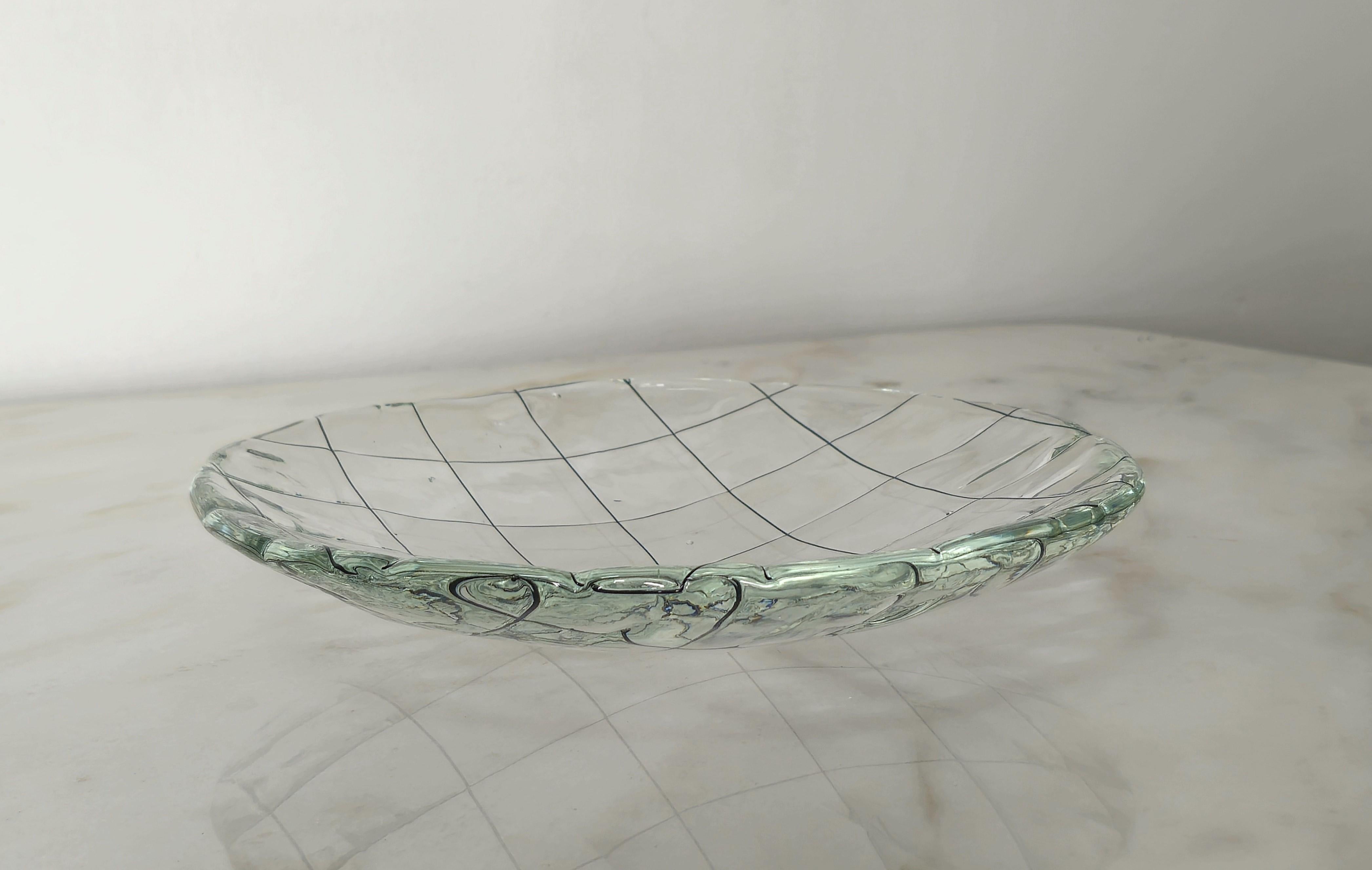 Circular plate made of large thick Murano glass in the shade of transparent with black lattice decoration. Made in Italy in the 1950s.


Note: We try to offer our customers an excellent service even in shipments all over the world, collaborating