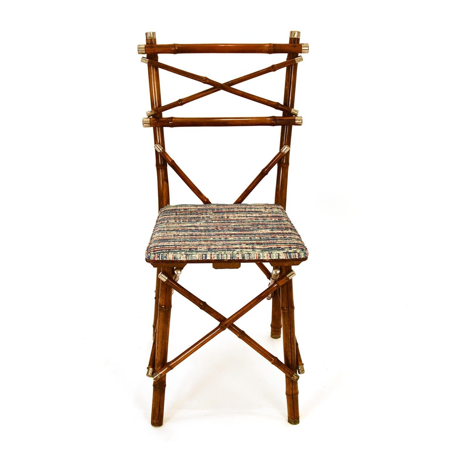 A decorative bamboo chair which was made in Vienna circa 1920 by J. Kothgassner - Bambus & Phantasie-Möbel, Gumpendorferstrasse 57.
The ends of the bamboo rods have a nickel plated brass cup. The chair has 1 missing cup at the feet.
It is labeled