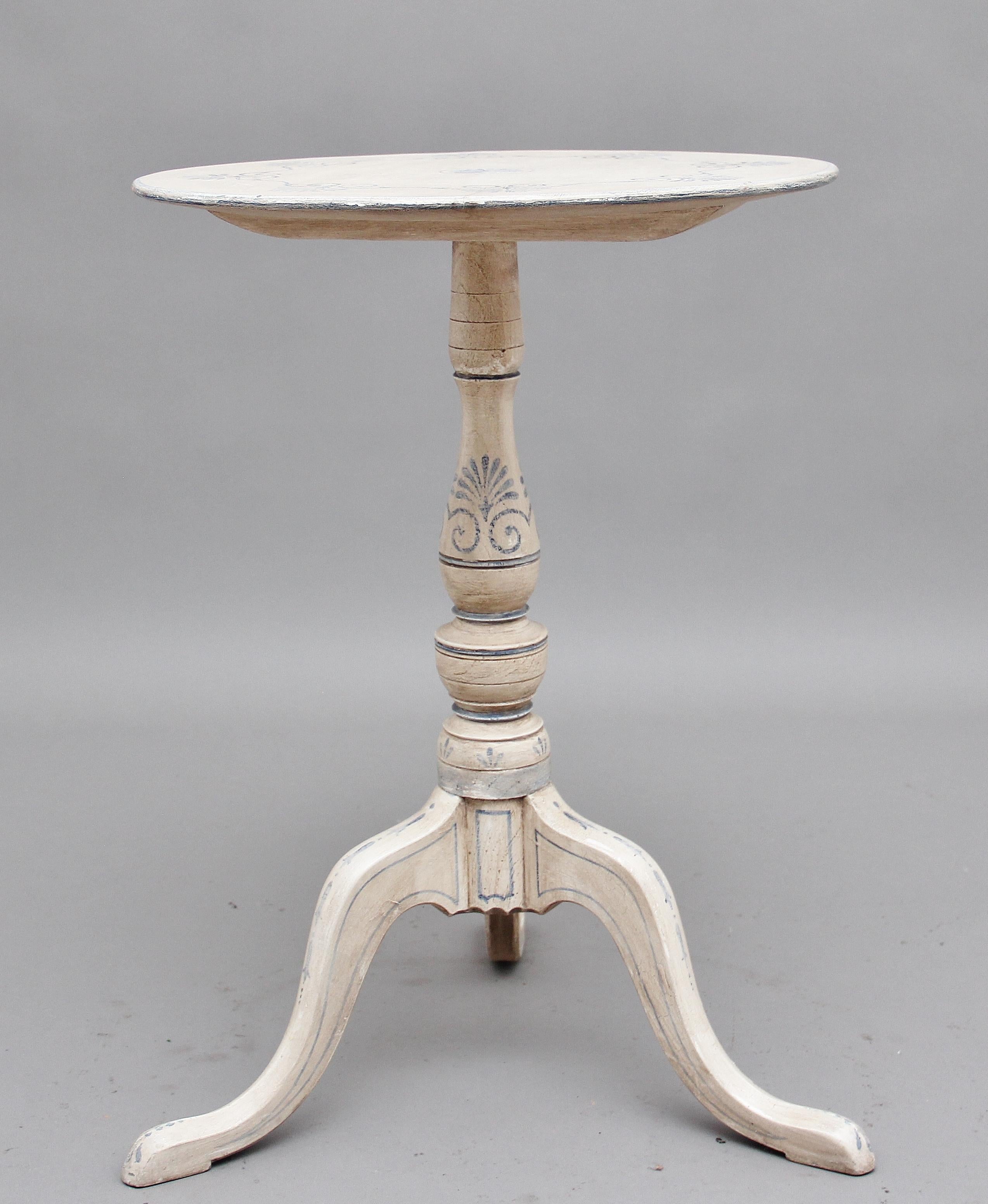 A decorative early 20th century painted tripod table, the circular top having a nice blue painted design, supported on an elegant turned column terminating with three slender shaped legs, circa 1780.