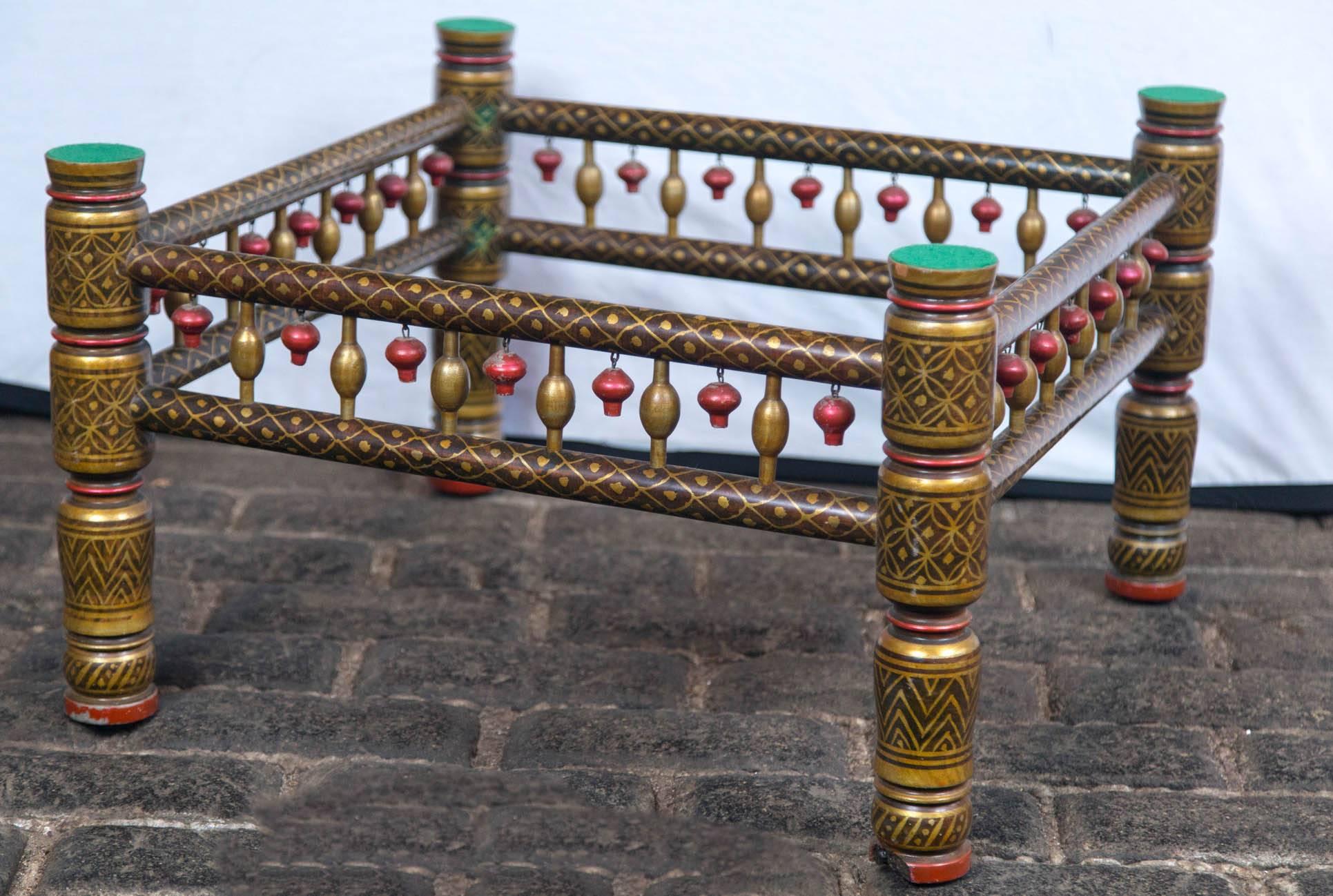 Fanciful Anglo-Indian style painted wood table base with red accents and carved wood 