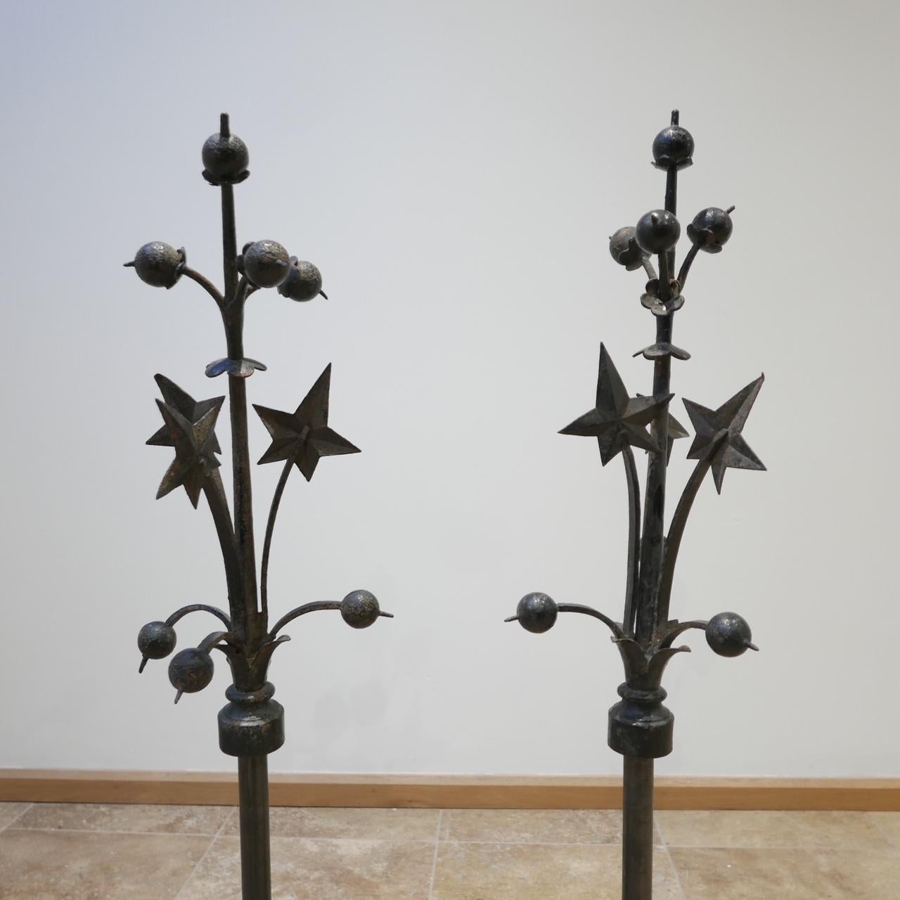 A pair of garden finials with later custom blacksmith made stands.

Very decorative with improved functionality with the stands so they can be used internally.

Likely French, circa 1920s. 

Painted black at some point. 

Price is for the