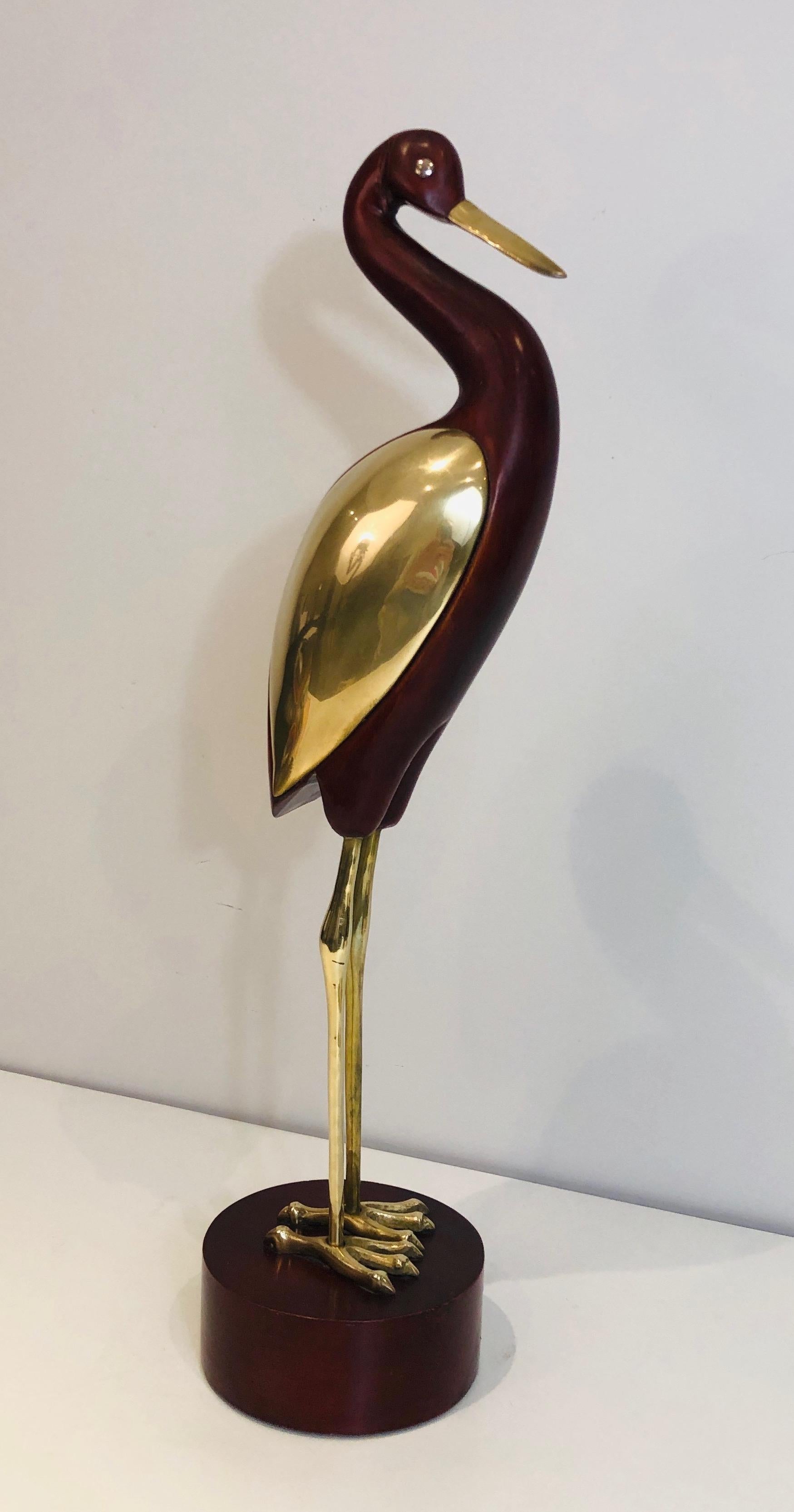 This decorative bird is made of exotic wood and brass. This piece has a little restoration on the neck. This is a French. work, circa 1970.

 