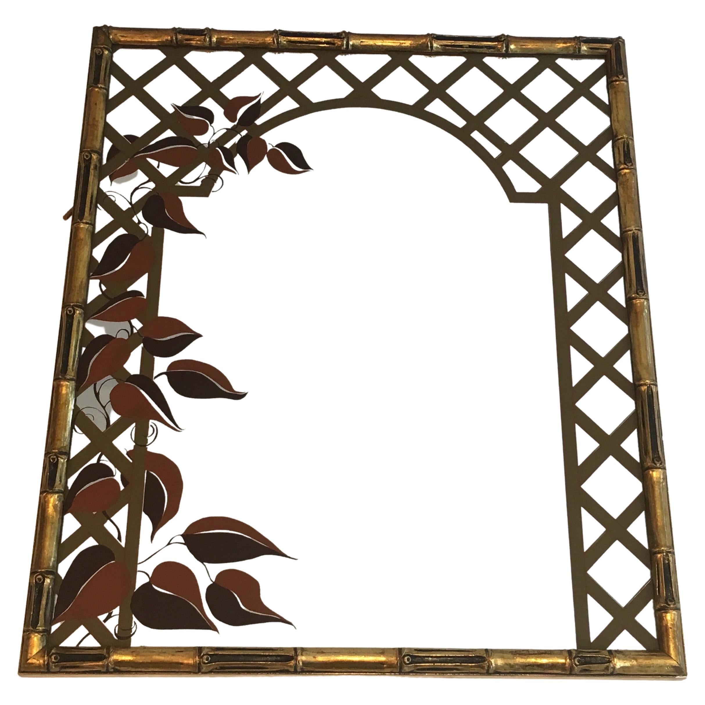 This decorative faux-bamboo mirror is made of gilt wood with printed floral decor. This is a French work/ Circa 1970.