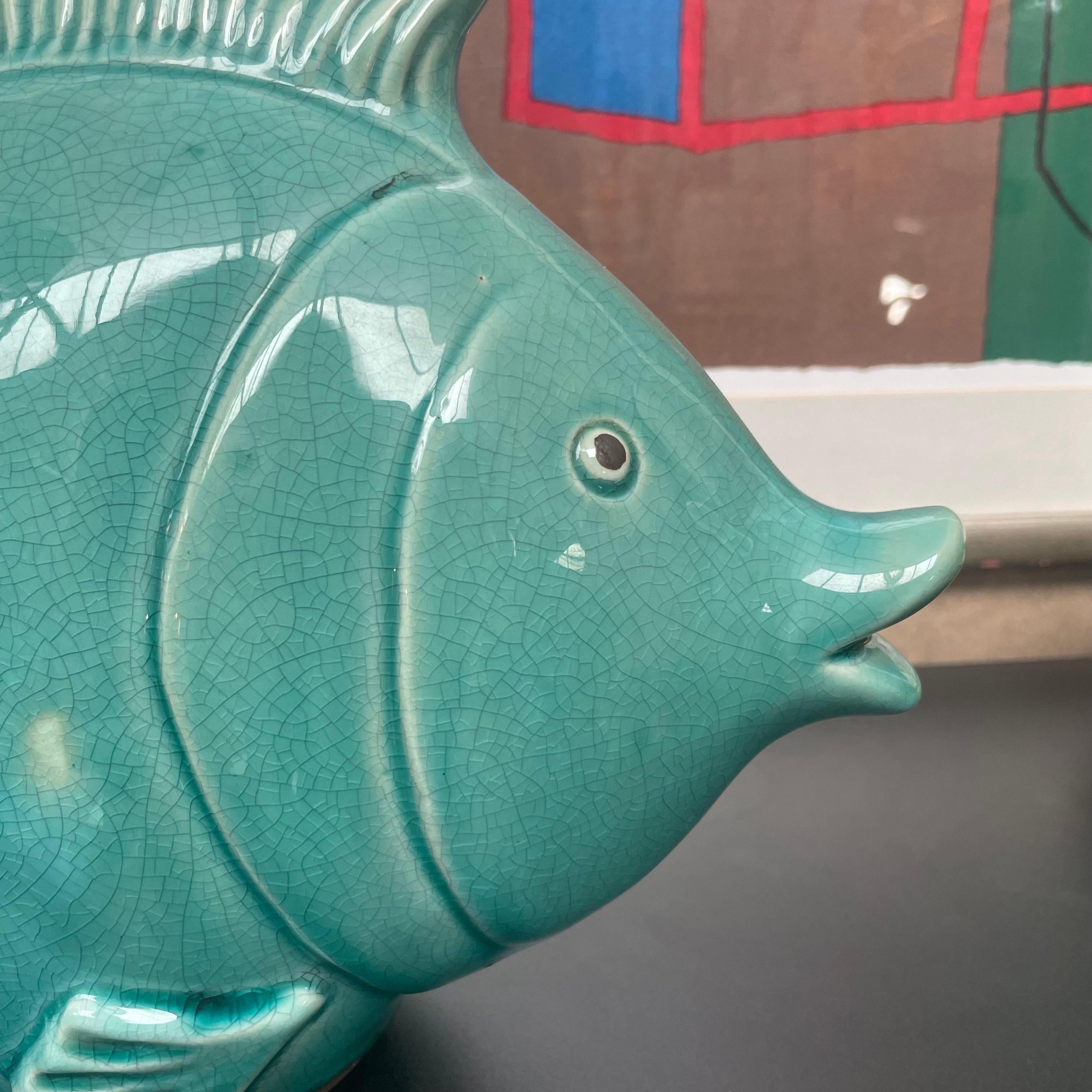 Decorative Fish in Glazed Ceramic, late 20th century.

Wonderful and fun decorative fish sculpture in glazed ceramic. Deep and interesting turquoise color and a playful yet elegant design. Due to the size and scale this is a great piece to show on a