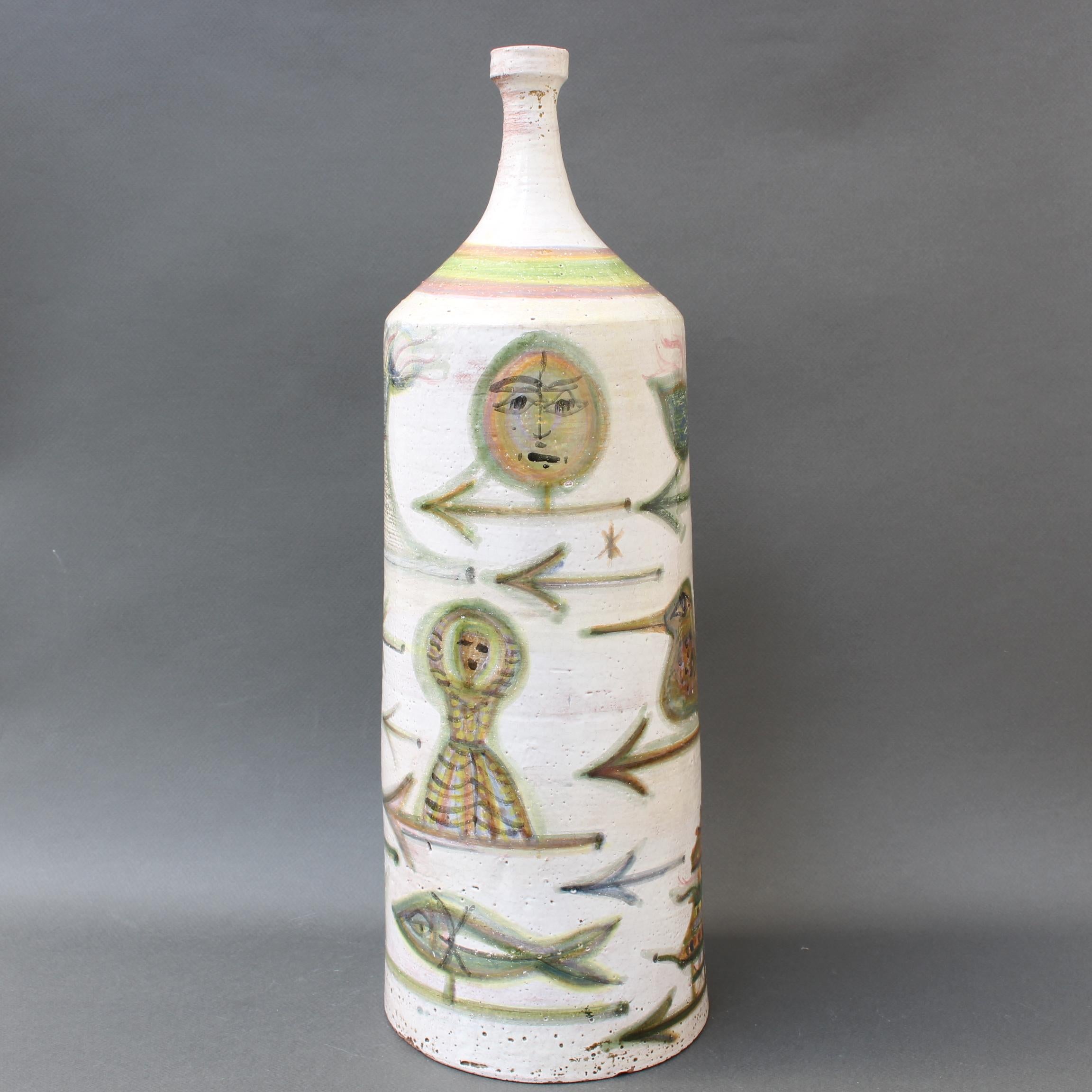 Decorative ceramic bottle-shaped vase by David Sol, Sant Vicens pottery (circa 1950s). Truly a unique piece, the figures in the fanciful motif - humans, animals, plants, building structures and fish in the ocean dwell on the form accentuated by