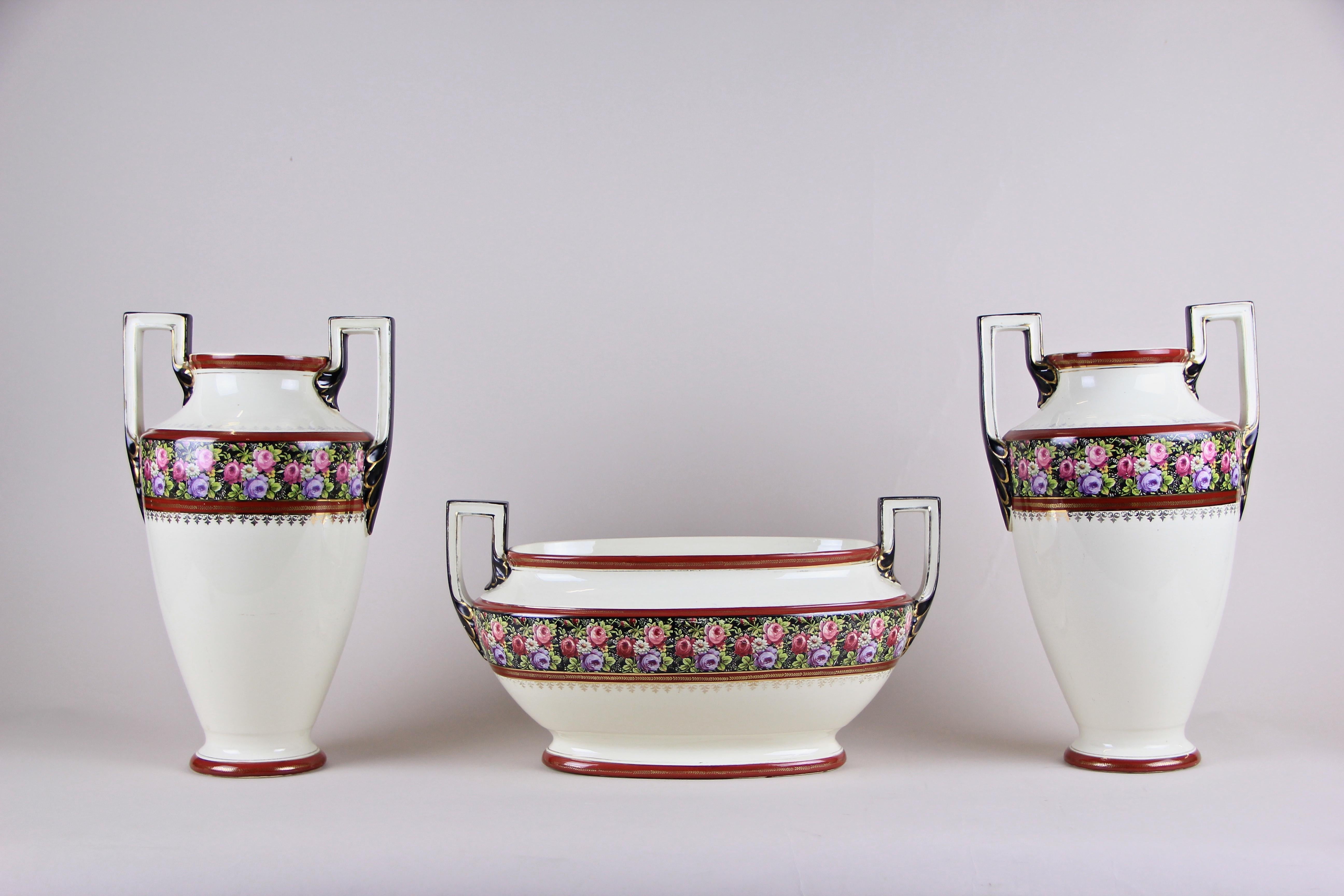 Lovely French ceramic garniture from circa 1910. This Art Nouveau set consists of five pieces including two large beautiful designed Amphora vases, a jardinière and two small straight vases. Nice flower designs adorn all pieces in this great