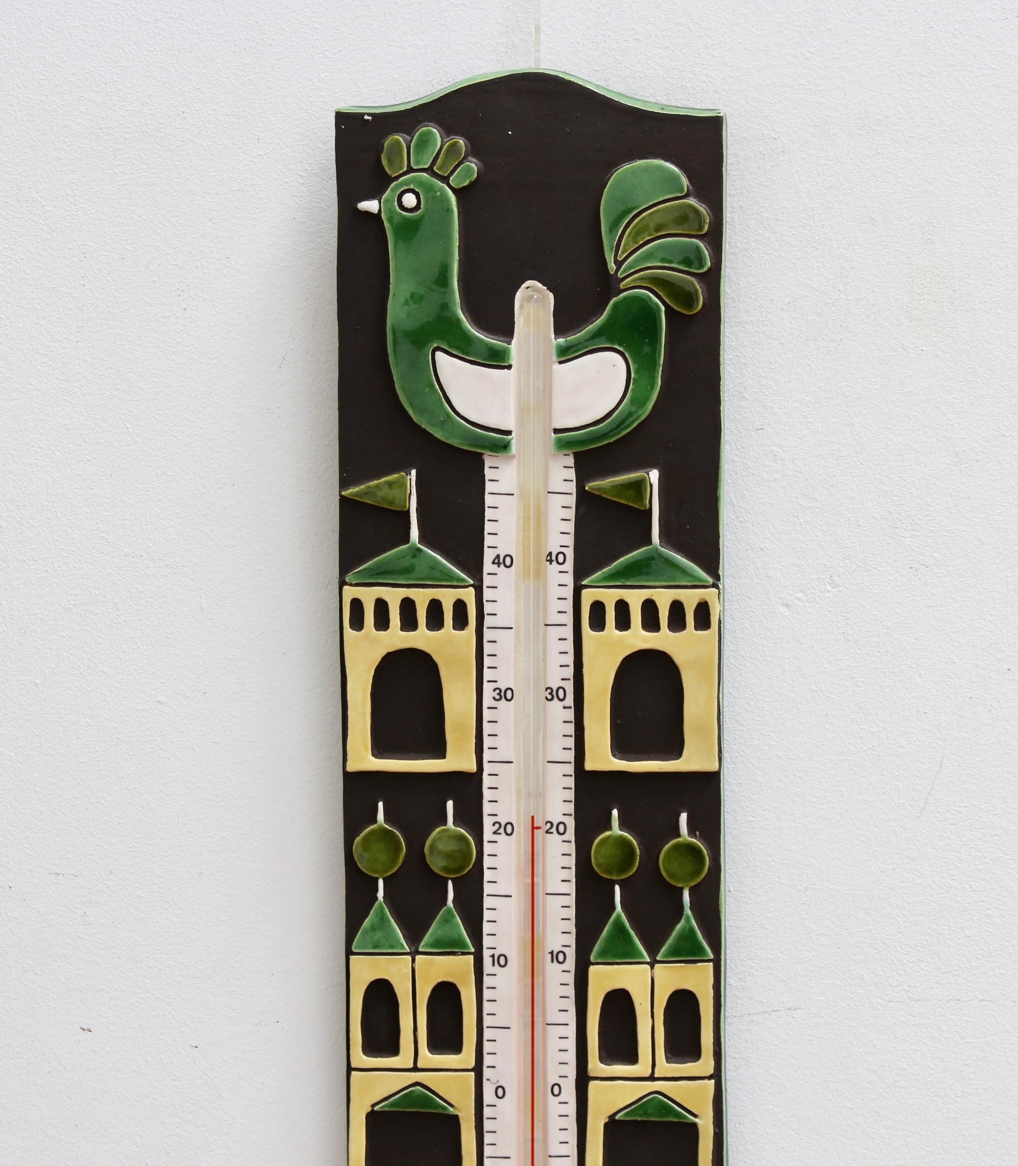 Decorative, French vintage ceramic thermometer and casing by Mithé Espelt (circa 1960s). A delightful piece with stylised French coq and castle motifs. The hen is in a lovely deep green and a creamy white; the castles are yellow and green. With a