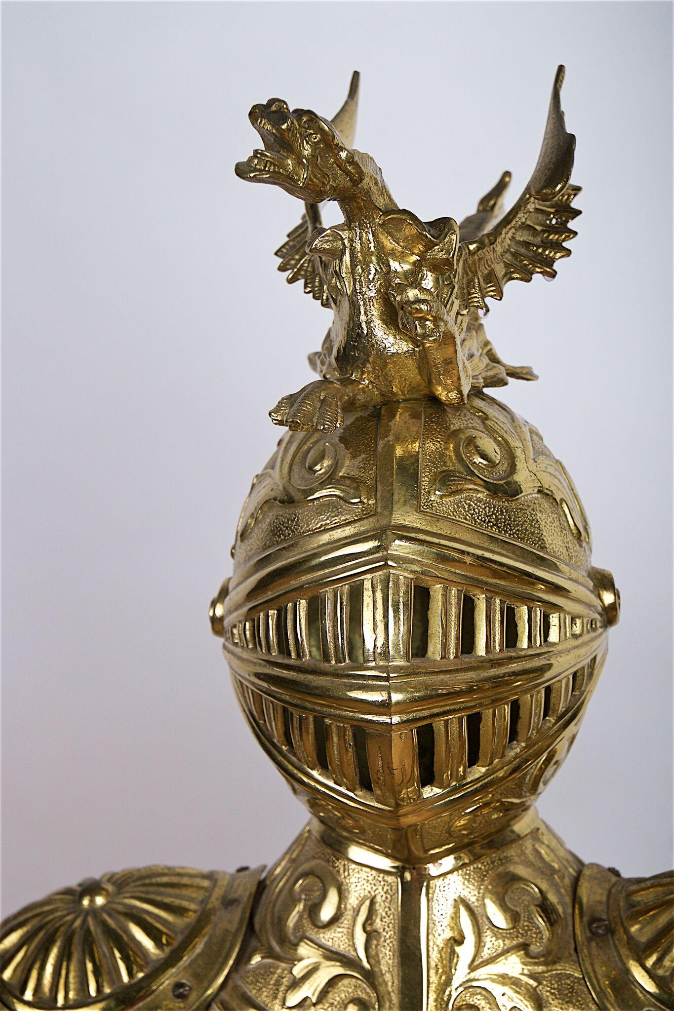 Late 19th century English decorative gilded bronze lamp in the form of a man in armour, on ebonised base with shield.