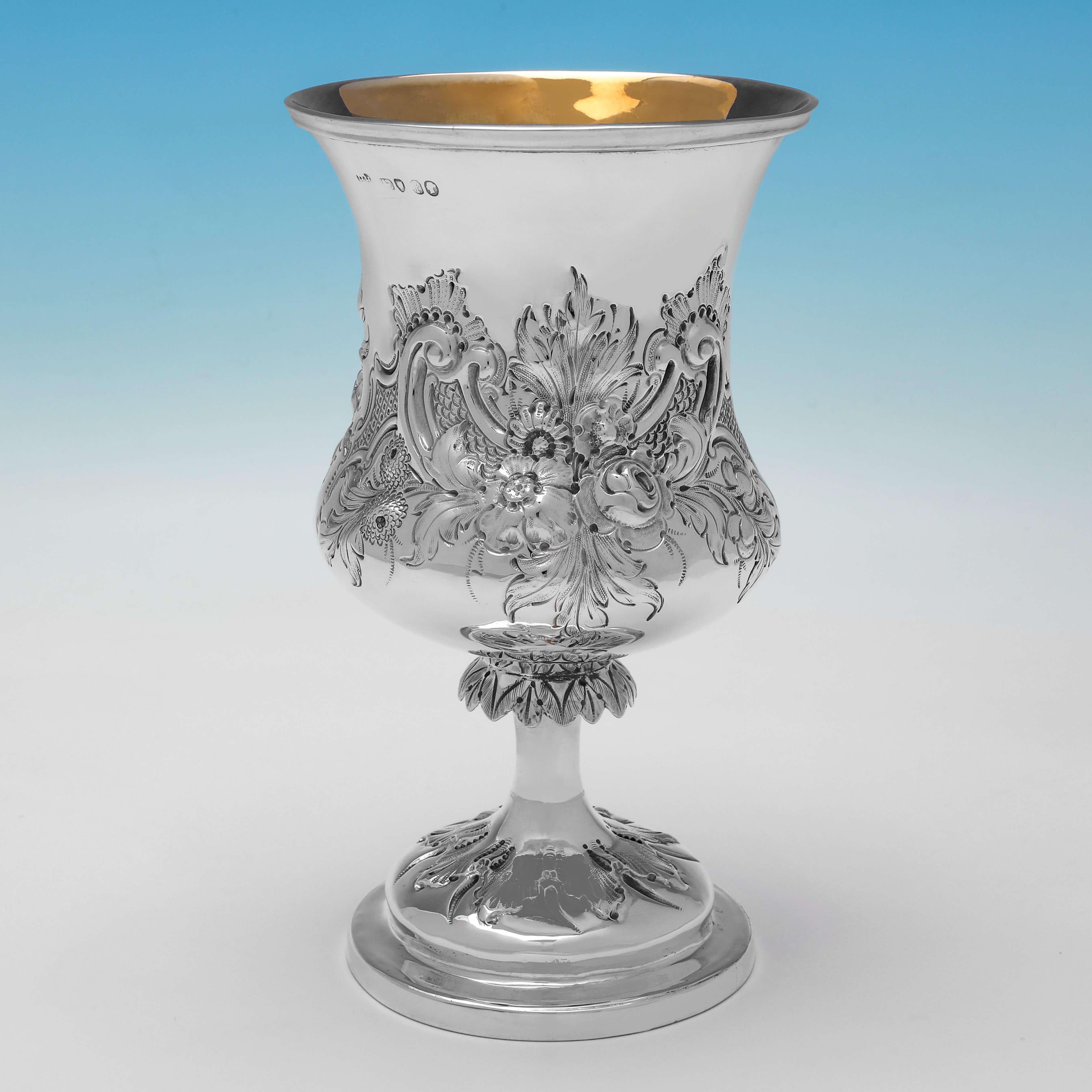 Hallmarked in London in 1861 by Henry Holland, this stunning, Victorian, Antique Sterling Silver Goblet, is campagna shaped, and features chased floral and scroll decoration to the body and foot, and a gilt interior. 

The goblet measures 7