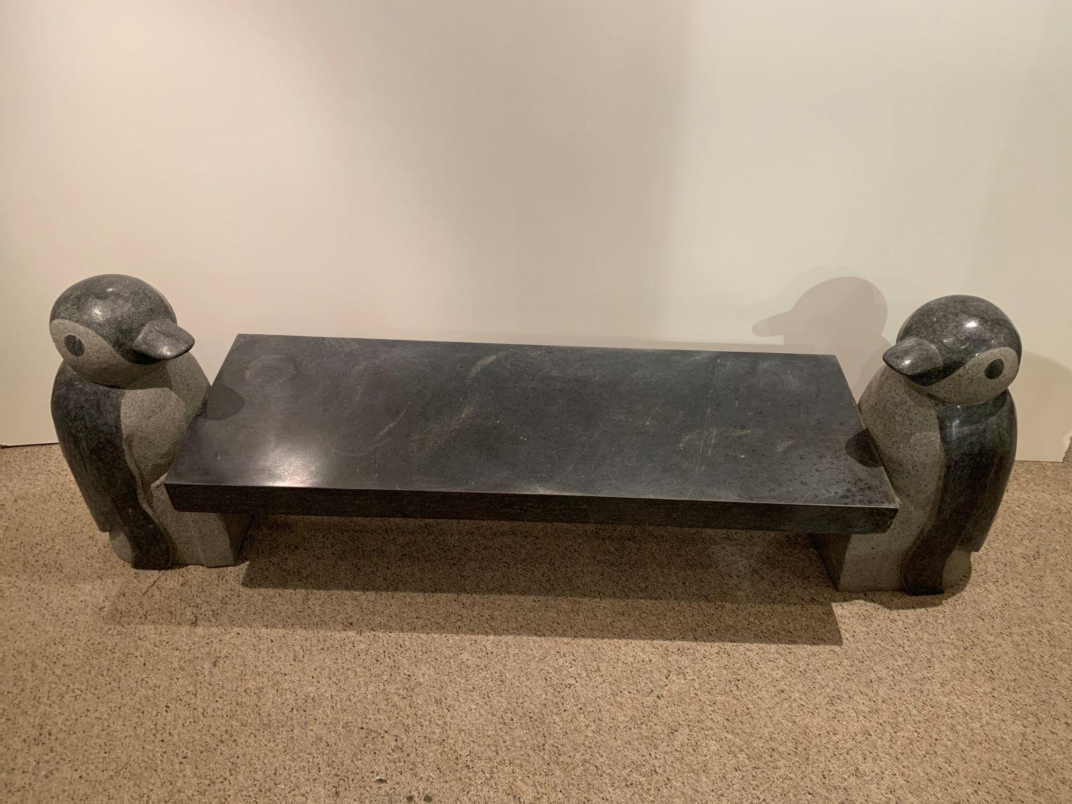 Exceptional and decorative three-piece granite penguin bench or cocktail table. The design is very much in the style of Jeff Koons. The granite does have some small chips to the rectangle center slab piece as to be expected with age and use. The