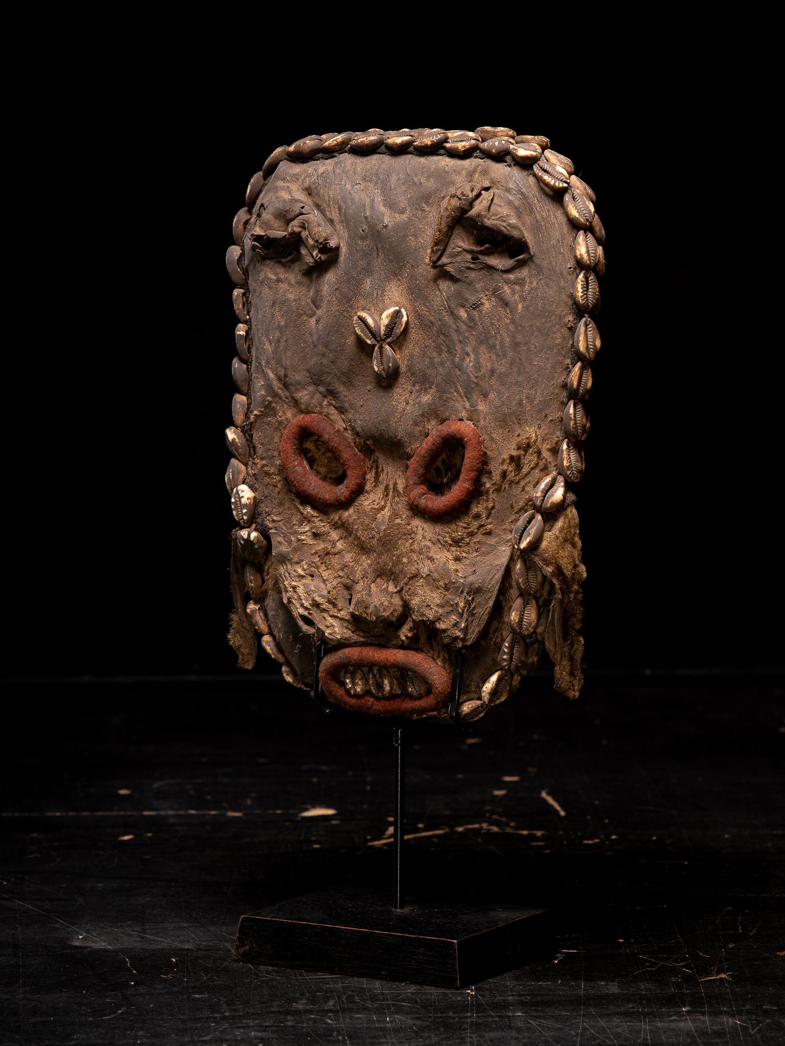 Decorative Grassland Leopard skin Mask

Private collection Brussels 

The raffia splint is covered with cloth and colourful miniature glass beads in various forms and sizes .The embroidery is arranged in geometrical patterns and motifs representing