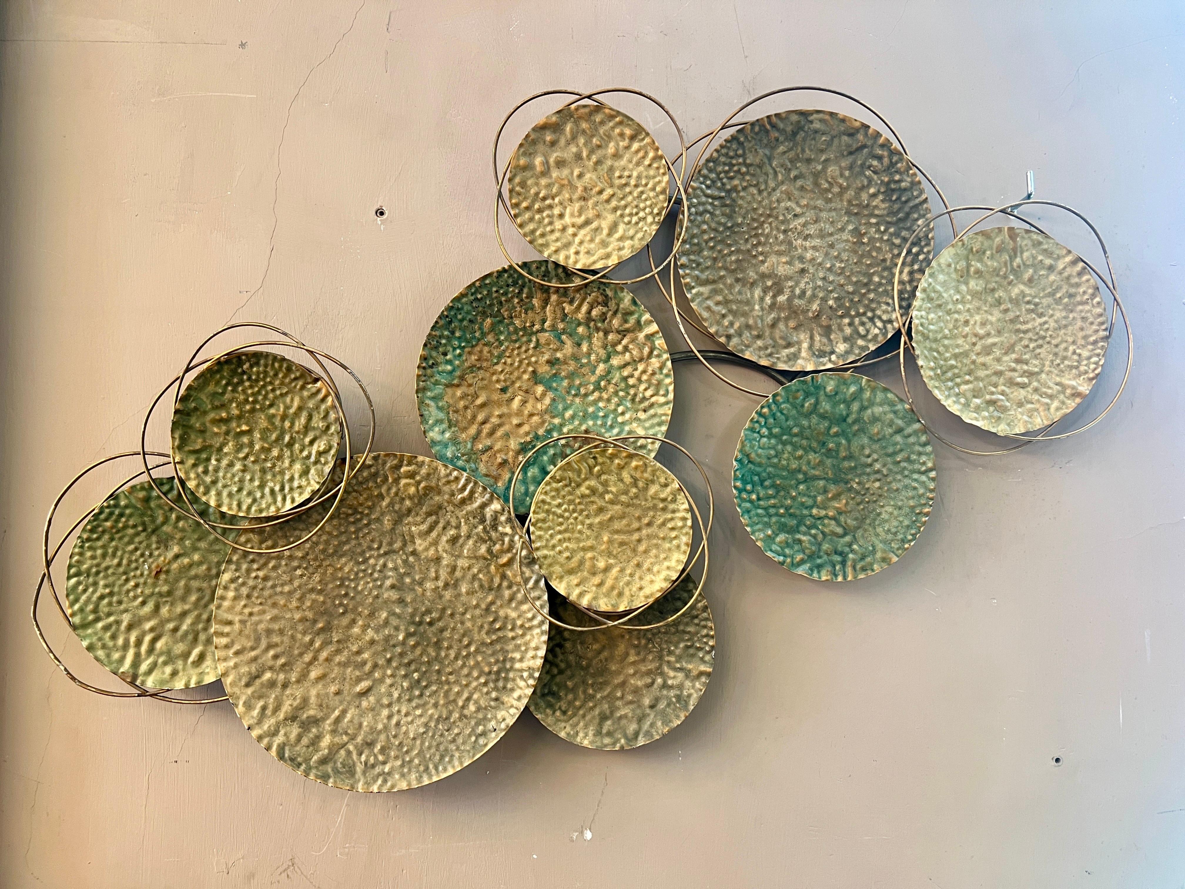 Decorative Bronze Wall Sculpture created by layering hammered bronze circles, some of which have been oxidized by time and enhance the patina of the artwork