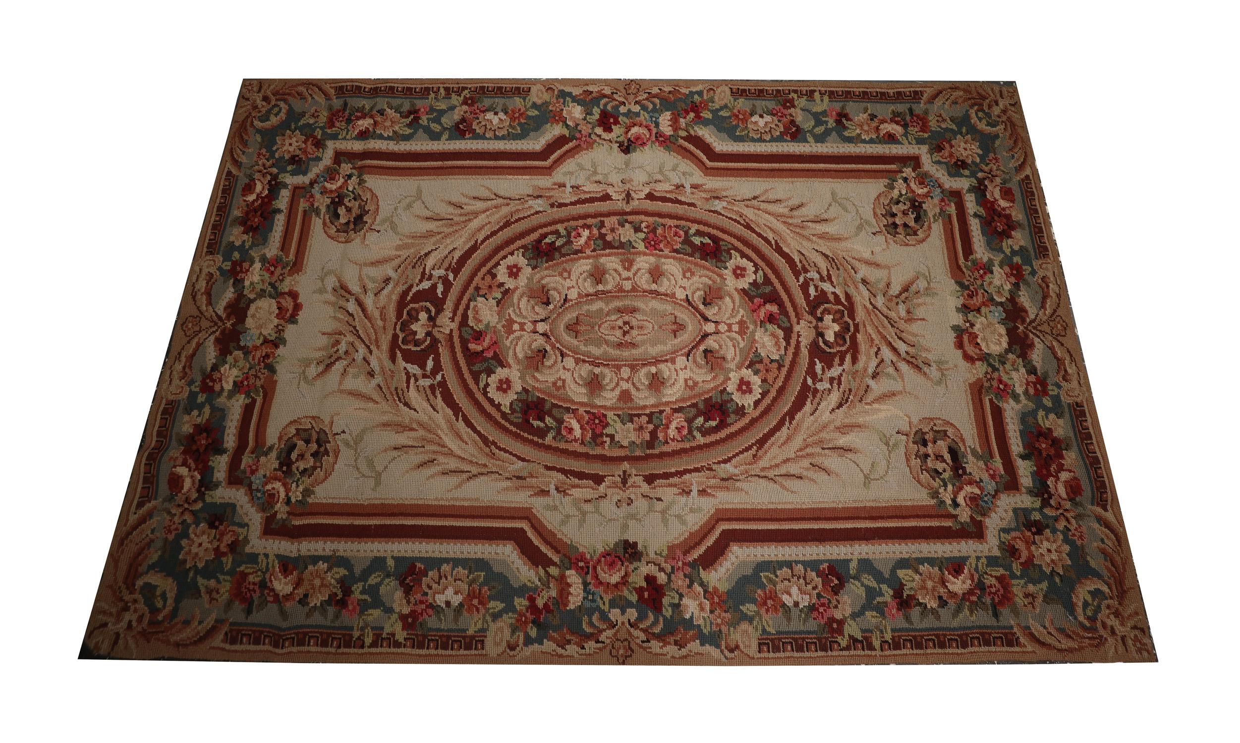 This highly decorative needlepoint rug was woven by hand in the early 21st century. The design has been intricately woven with sophistication. Featuring a bold central medallion that has been decorated with beautiful flowers and scroll details. This