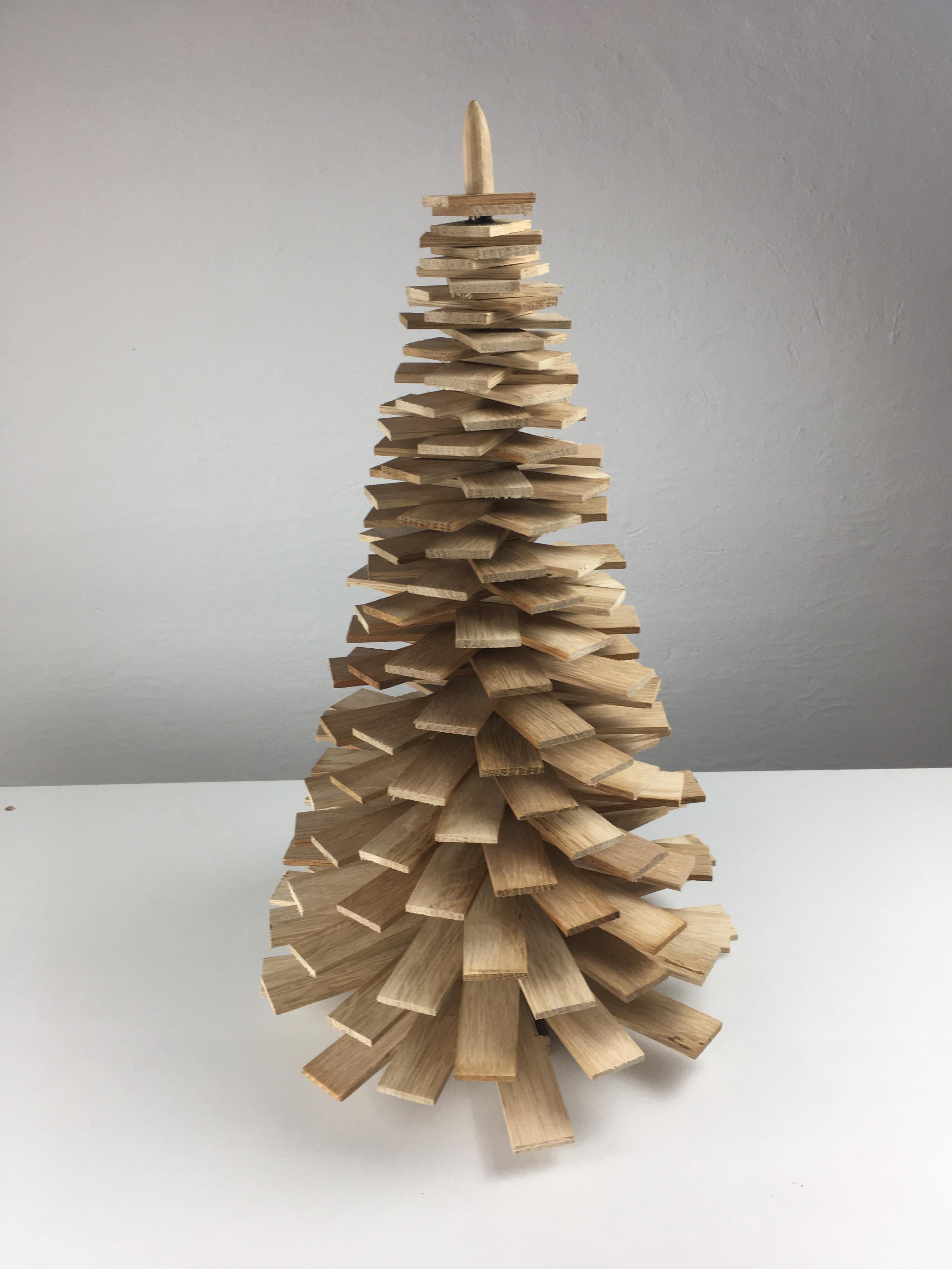 Large decorative handmade wooden Christmas trees in oak.

The Christmas trees are made of upcycled pieces of oak from furniture production that is normally beeing handled as waste - each Christmas tree is because of this uniqe why variation in