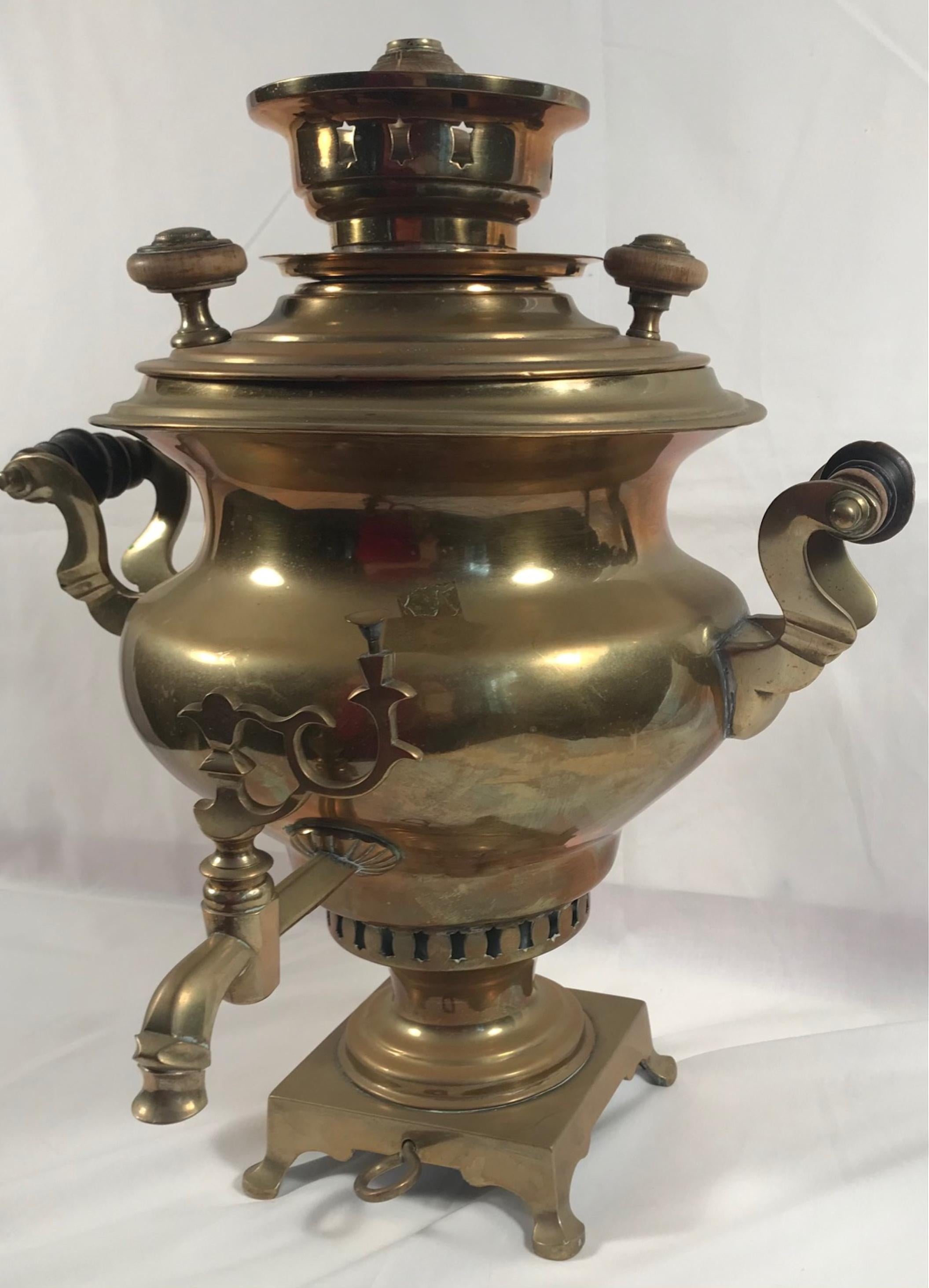 Decorative antique Imperial Russian Samovar, late 19th century

Beautiful 17 inch inverted pyriform shaped antique brass Samovar with decorated S-scrolled handle pieces. This samovar is set atop a square, footed base with pad feet. Makers marks on