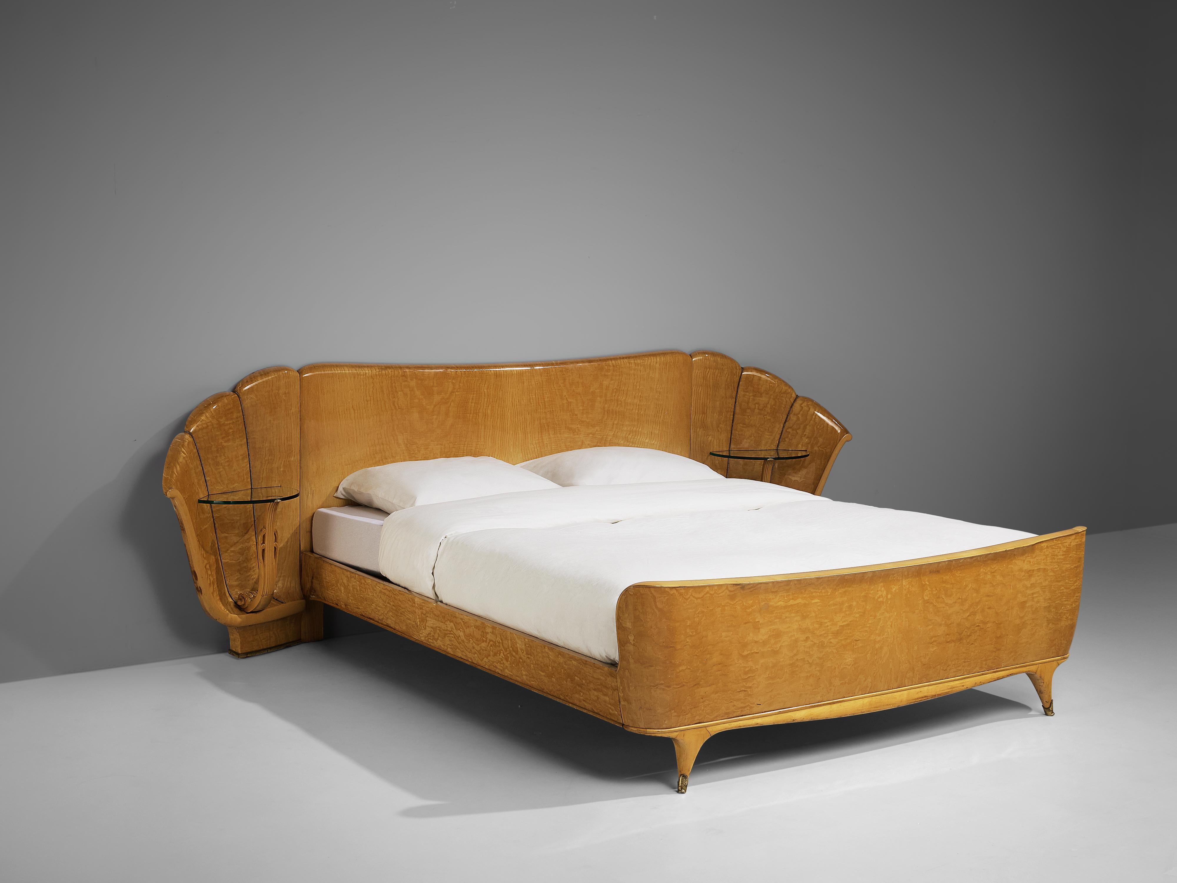 Italian double bed, ash, glass, brass, Italy, 1950s

Double bed with two integrated side tables. The shape of the headboard features a dynamic design with slightly curved sides and shell-like design. Vertical lines with little brass nails structure