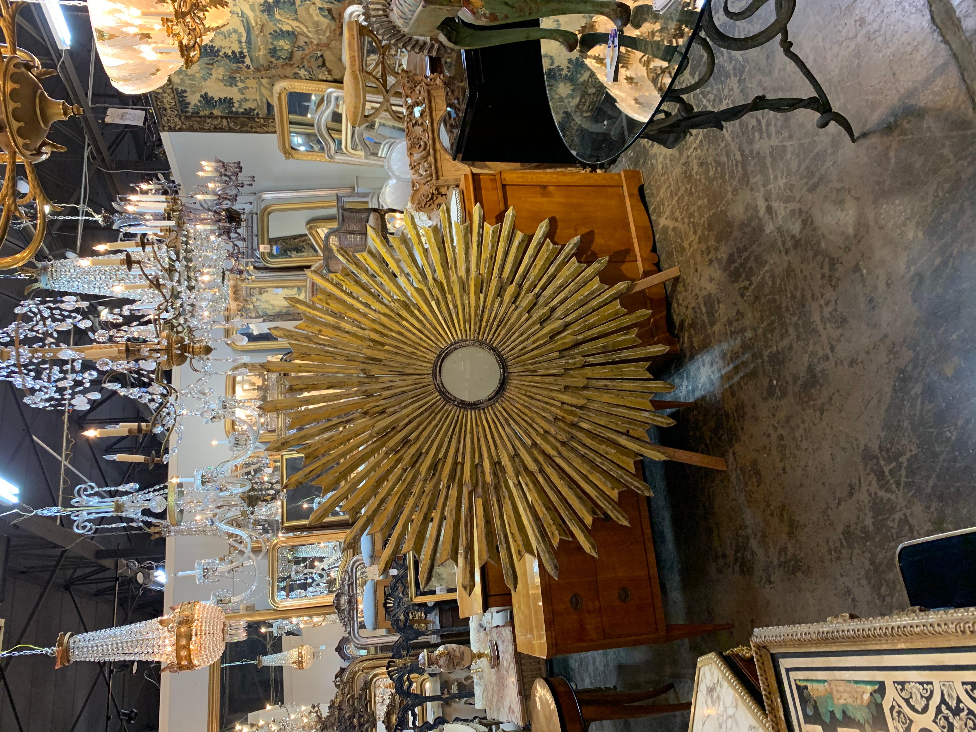 Extraordinary Italian large scale carved and patinated wood sunburst with a mirror in the center. This piece creates a beautiful textural element. A true work of art for a substantial impact!