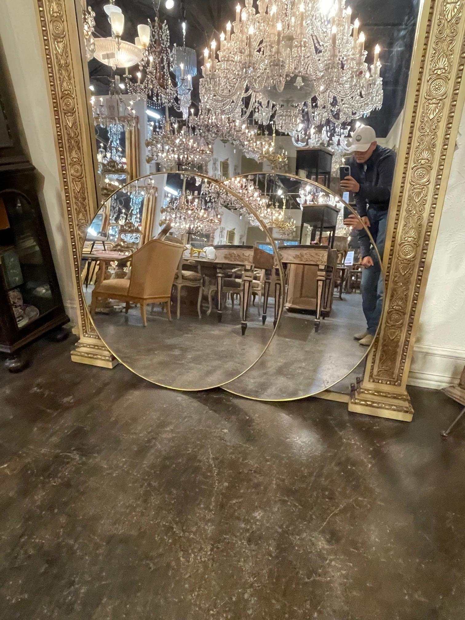 Gorgeous pair of round brass mirrors from Italy. Very fine quality and great for a variety of decors. Note: Price listed is per item.