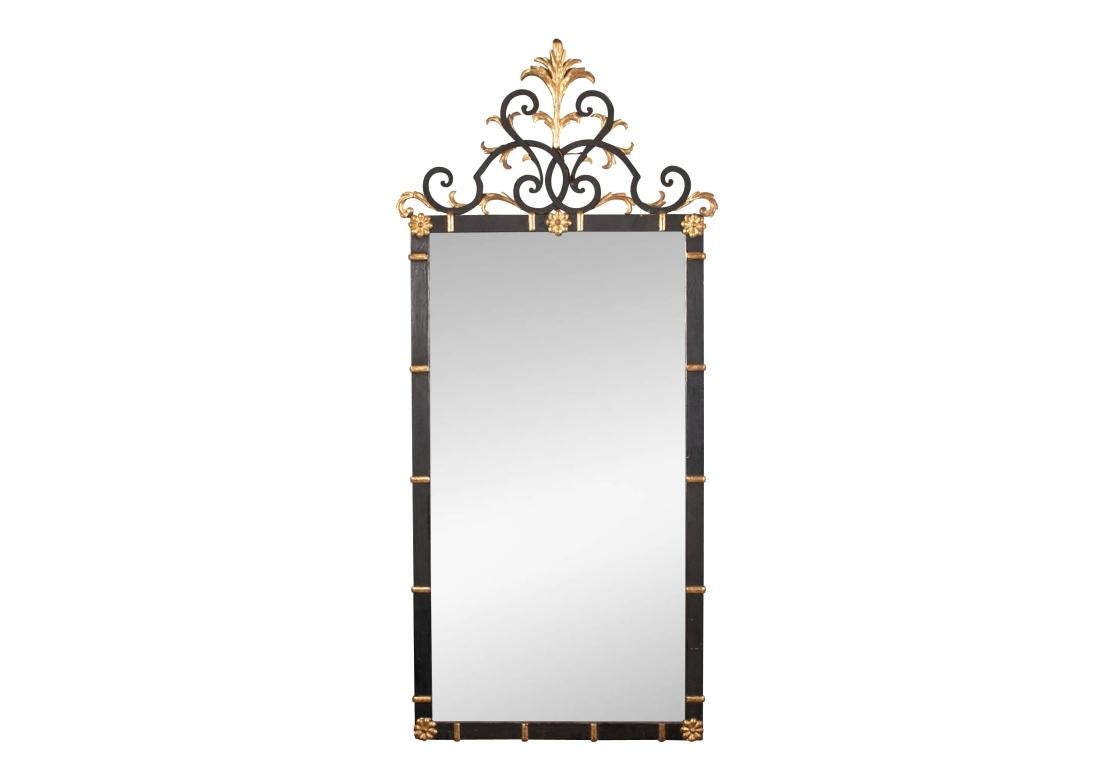 A tan Gilt and Painted Iron Pier Mirror with a delicate presentation. Black painted frame with a double scrolled top with gilt leaves and a gilt leafy crest. Gilt bars on the sides and rosettes in the corners. 

Condition: Please see detail photos.