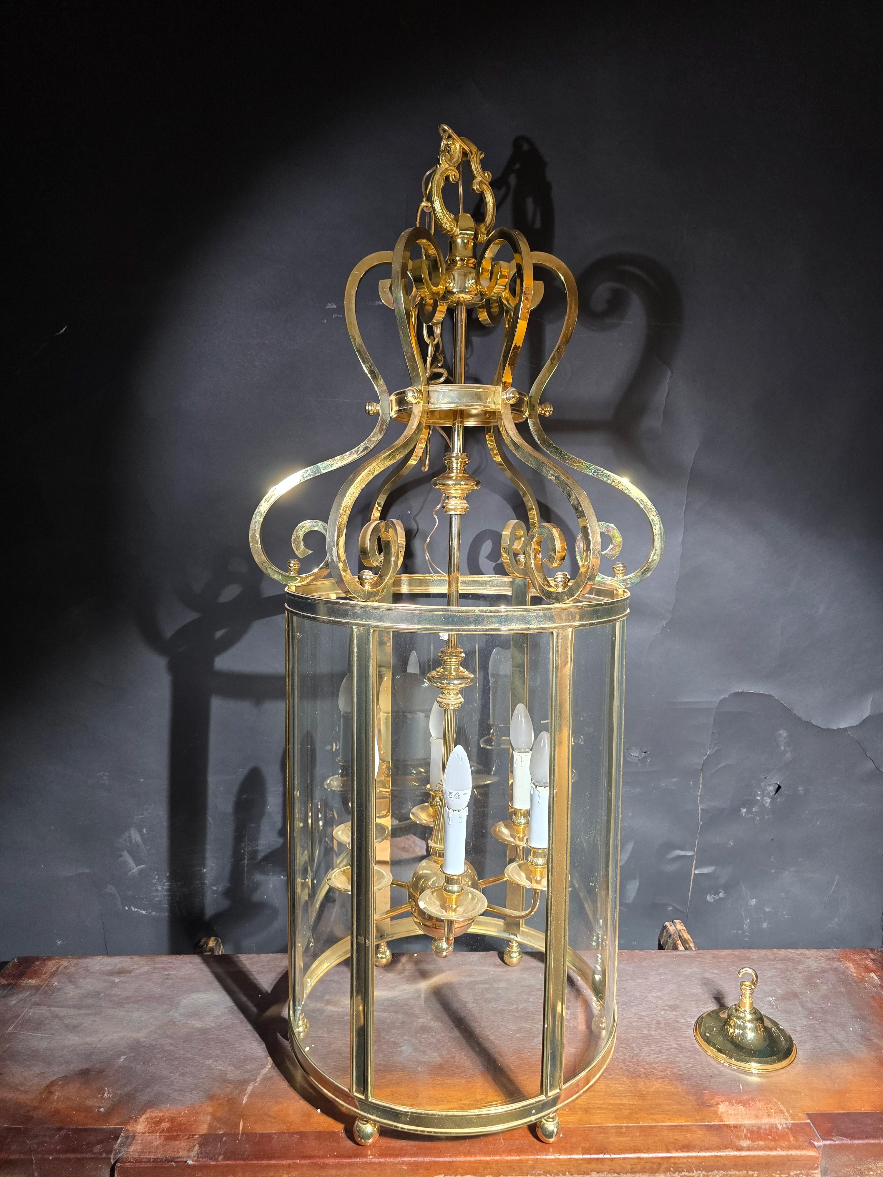 This striking and decorative lantern from the 1950s is crafted from gilt bronze and glass, combining elegance with a timeless design. Standing at an impressive height of 125 cm, it is in perfect working condition, making it a beautiful and