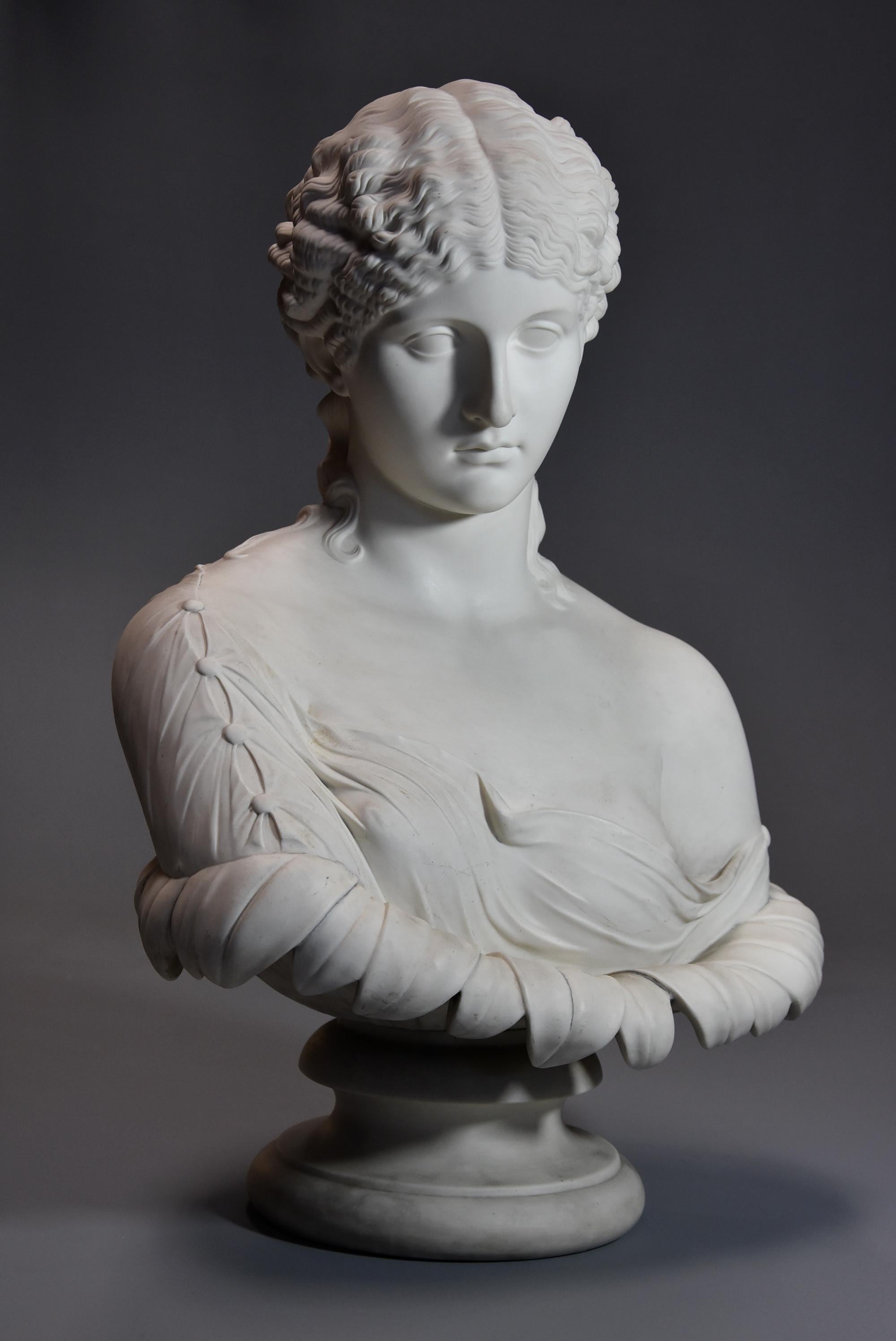 A highly decorative large mid-19th century Parian bust of ‘Clytie’, stamped ‘Copeland’.

This super figure depicts ‘Clytie’, her hair in Classical elaborate Roman style wearing traditional stola (traditional Roman dress) with button decoration