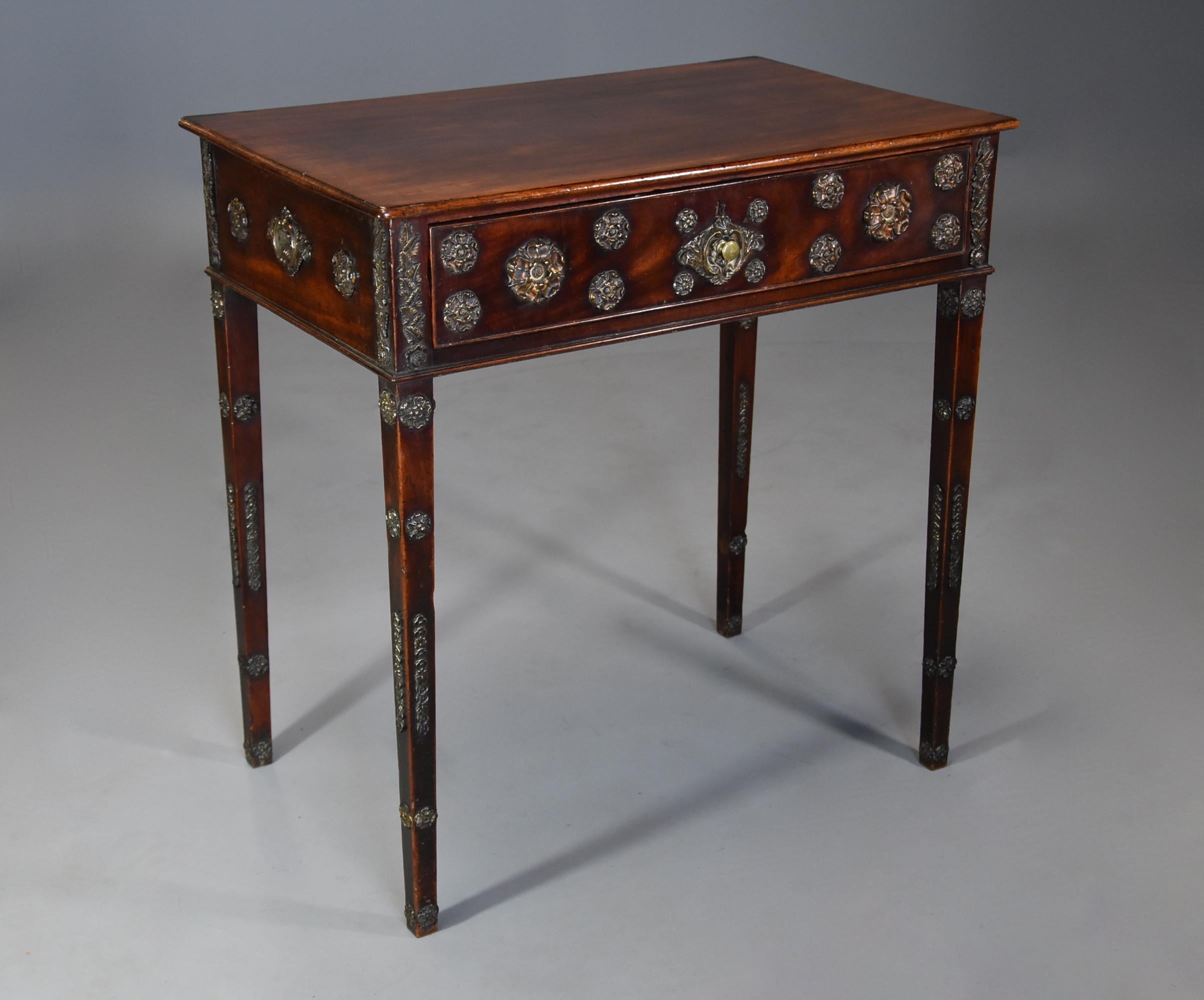 An unusual and highly decorative late 18th century mahogany side table of good patina with later applied brass paterae and mount decoration, the table dating to around 1790 and the mounts probably added around 1820-1830.

The table consists of a