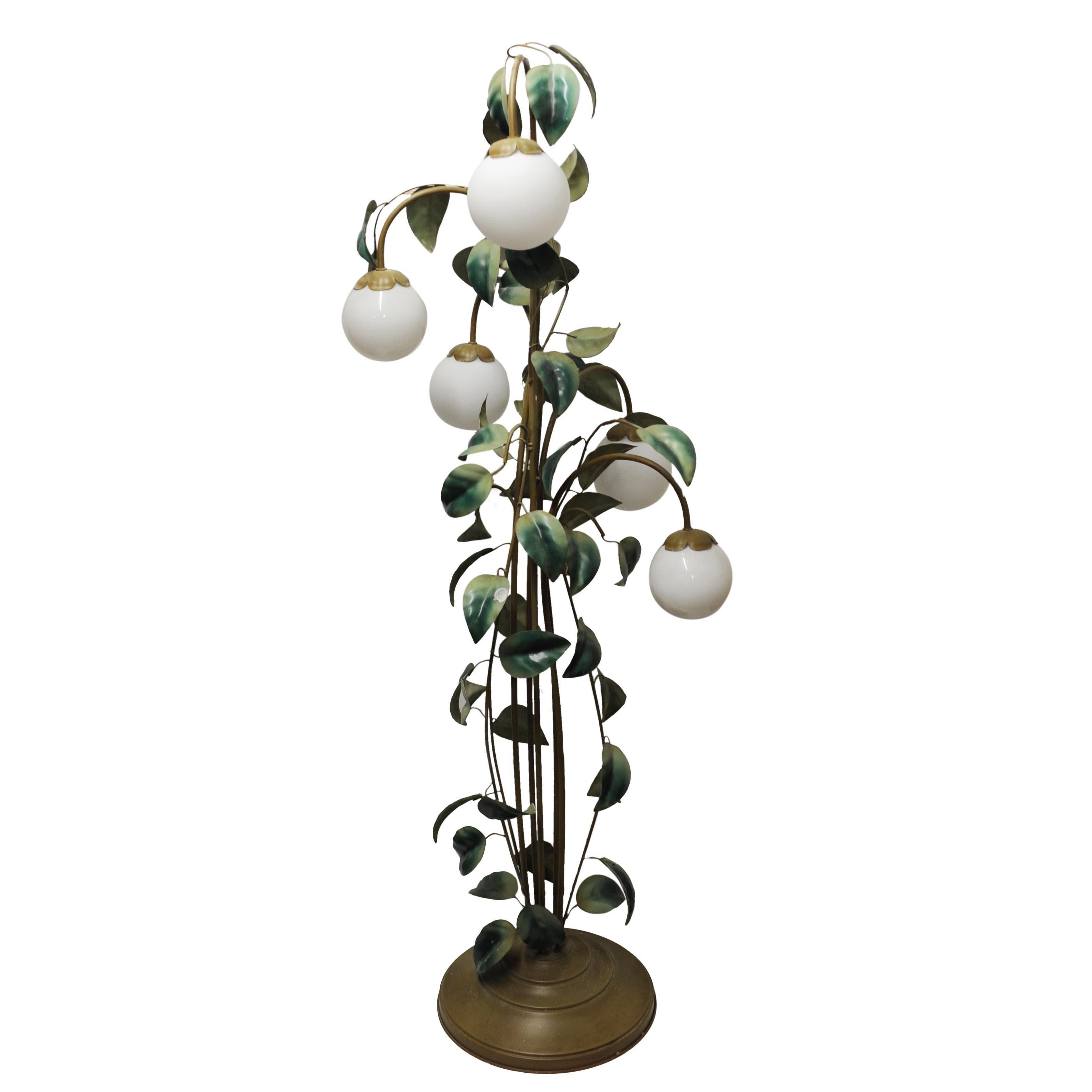 A 1970s painted metal leaf and vine floor lamp. The lamp has multiple green leaves and five white globes.

Manufacturer - attributed to Hans Kögl

Design Period - 1970 to 1979

Attribution Marks - n/a

Detailed Condition - Good with minimal defects.